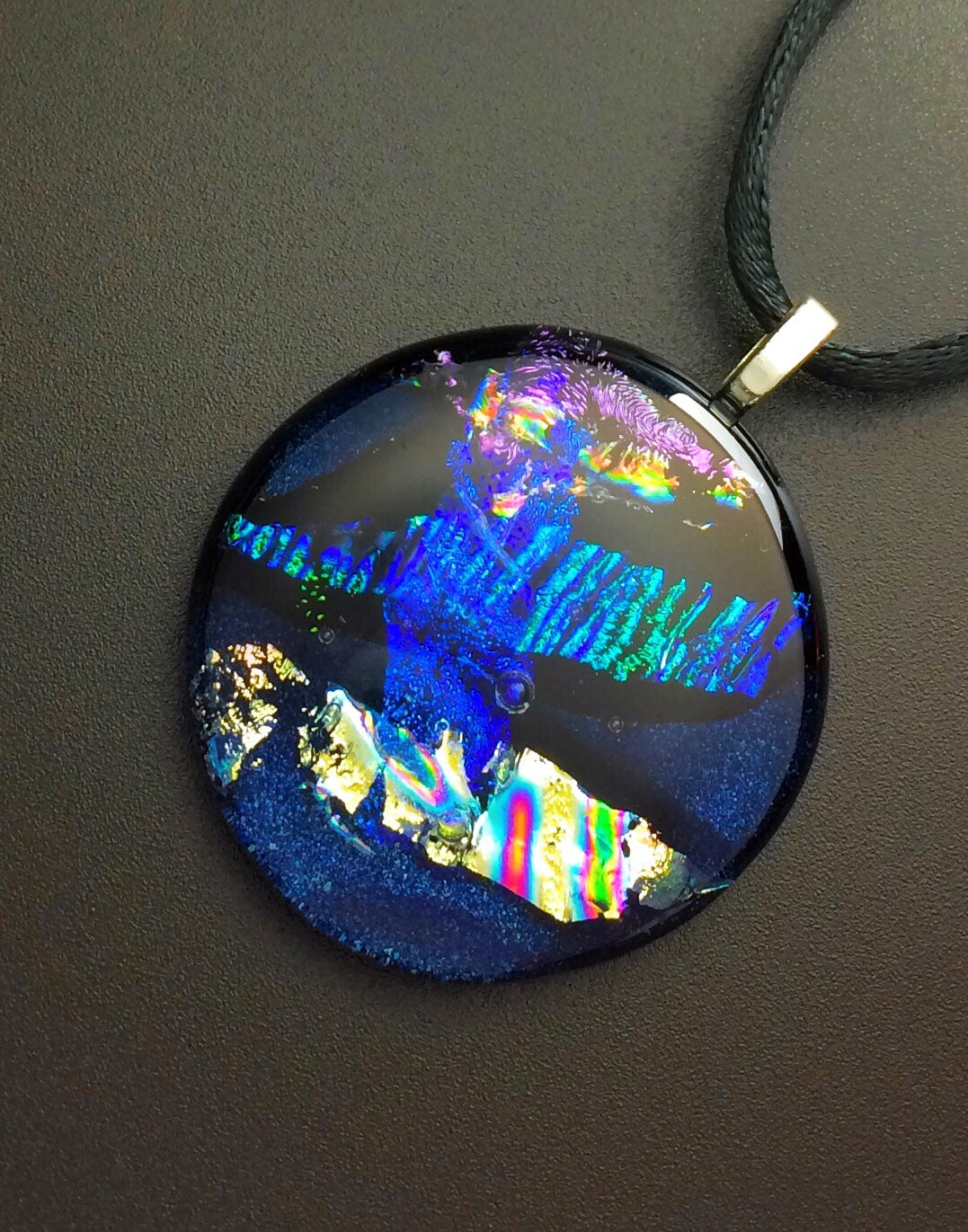 Round dichroic glass pendant in midnight blue, purple, silver and teal, by 3DGlass Designs.