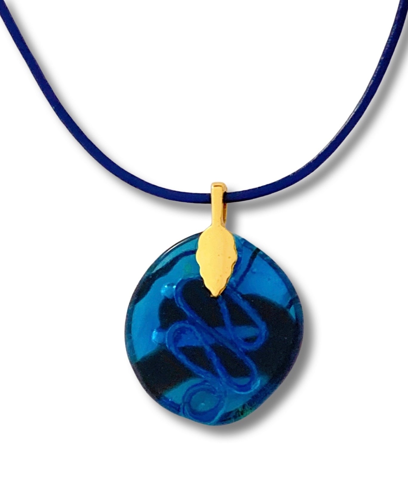 Back of blue fused pendant with copper squiggle design embedded in glass, by 3D Glass Designs.