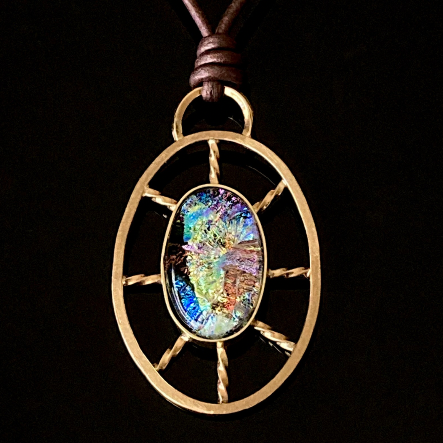 Nautical inspired multicolor dichroic glass set in a brass oval wheel shaped design, by 3D Glass Designs.
