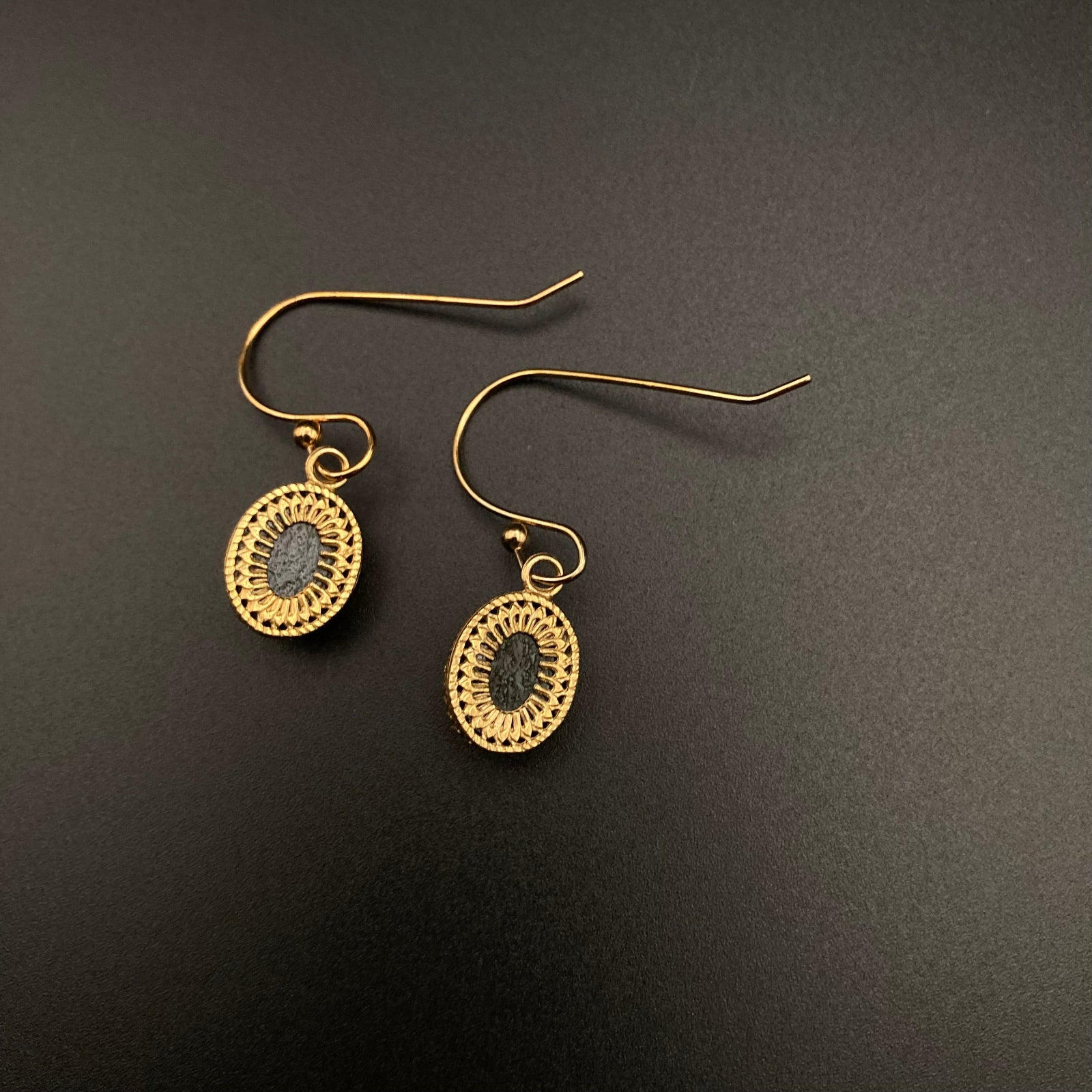 Backside of fused glass earrings set in unique brass setting, by 3D Glass Designs.