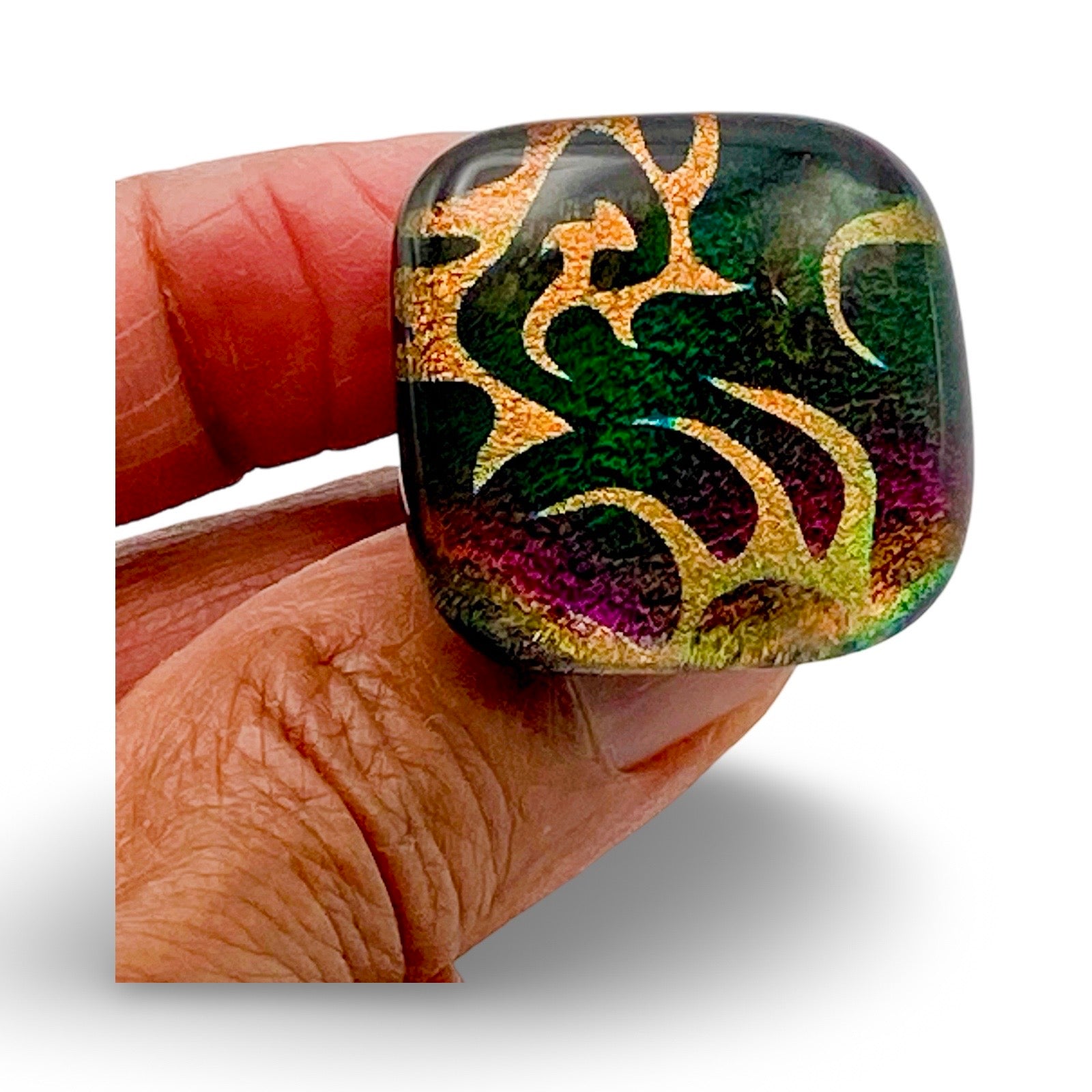 Hand holding handmade dichroic glass knob, by 3D Glass Design.