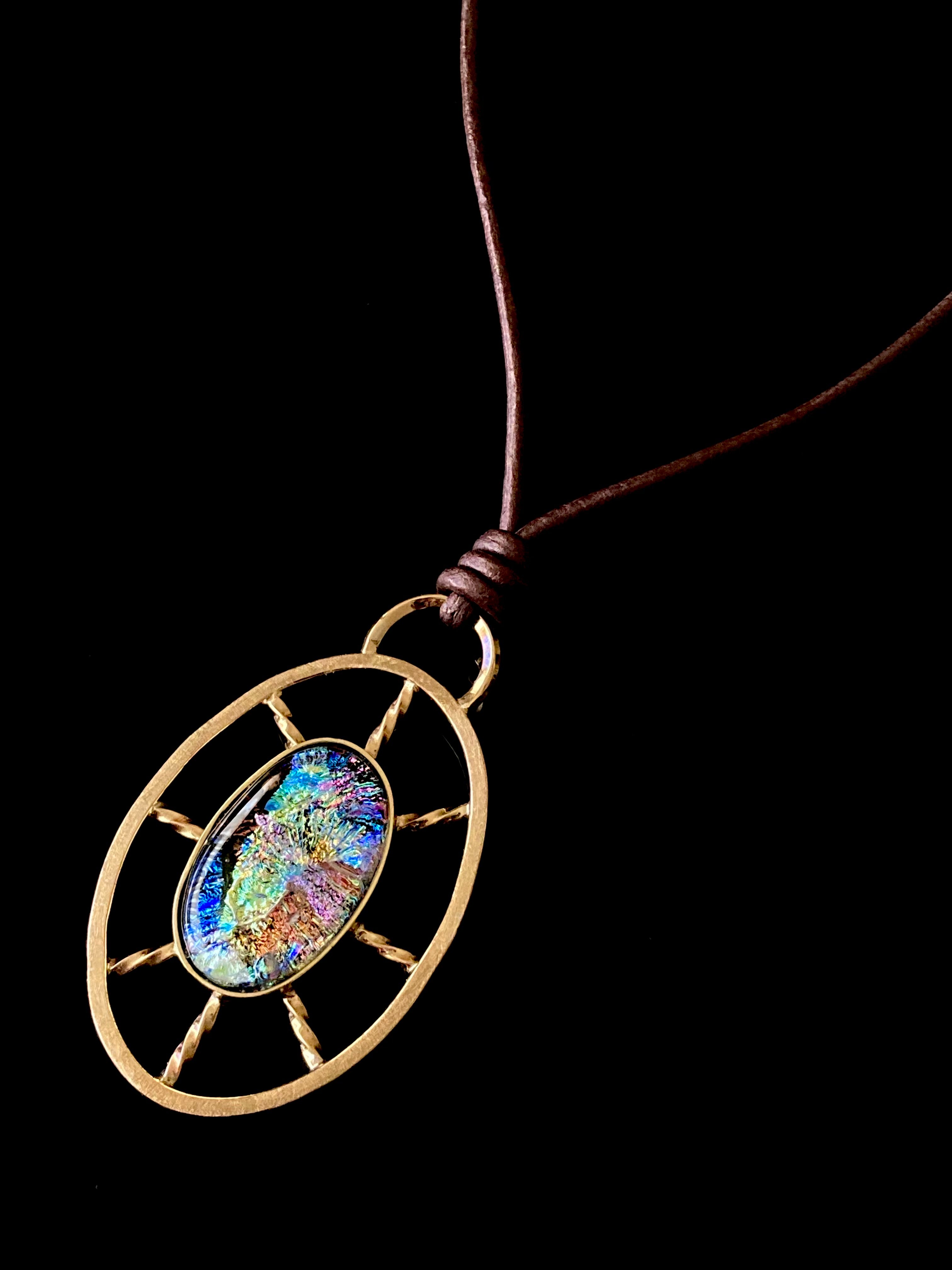 Nautical inspired multicolor dichroic glass set in a brass oval wheel shaped design, by 3D Glass Designs.