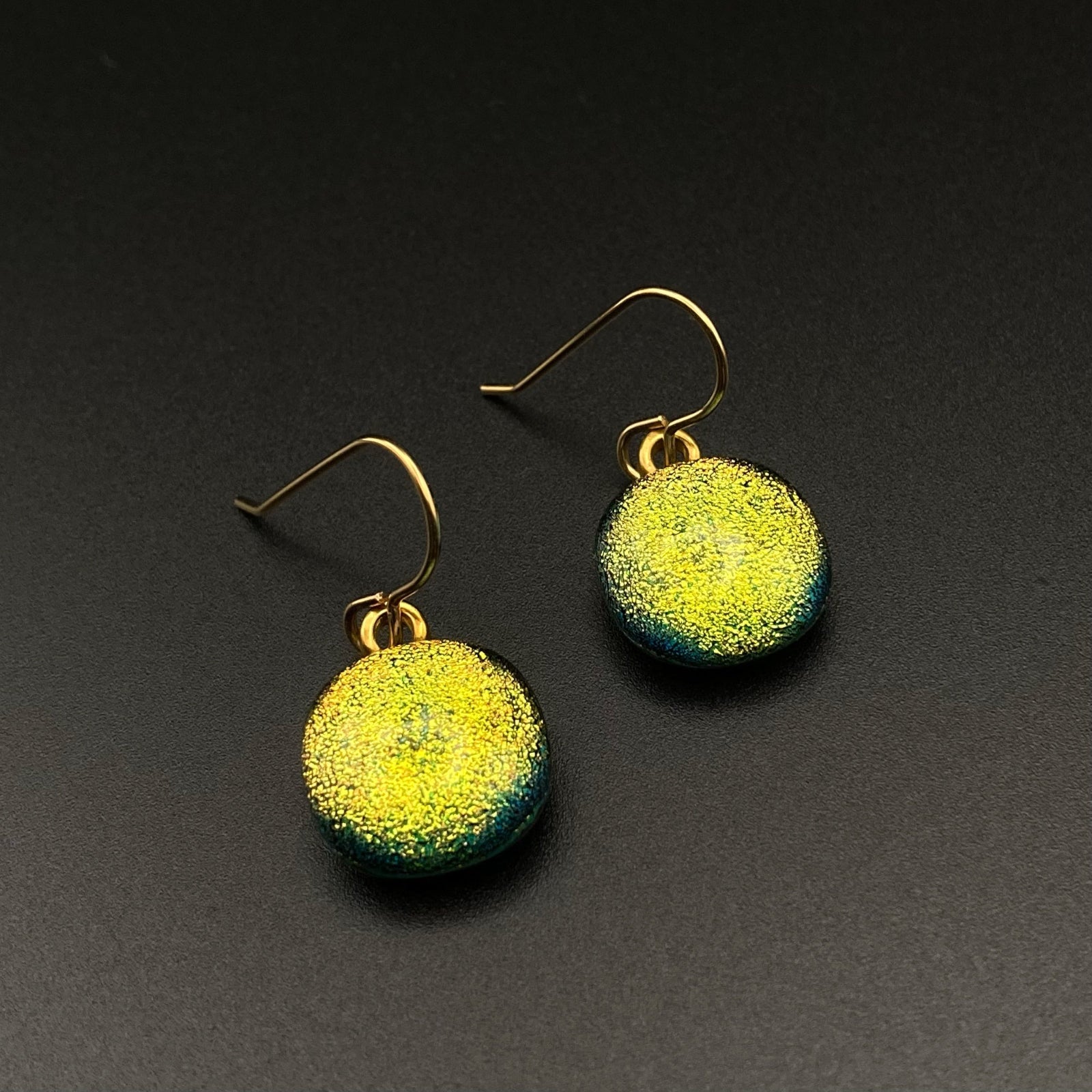 A pair of yellow earrings against a grey background by 3D Glass Designs.
