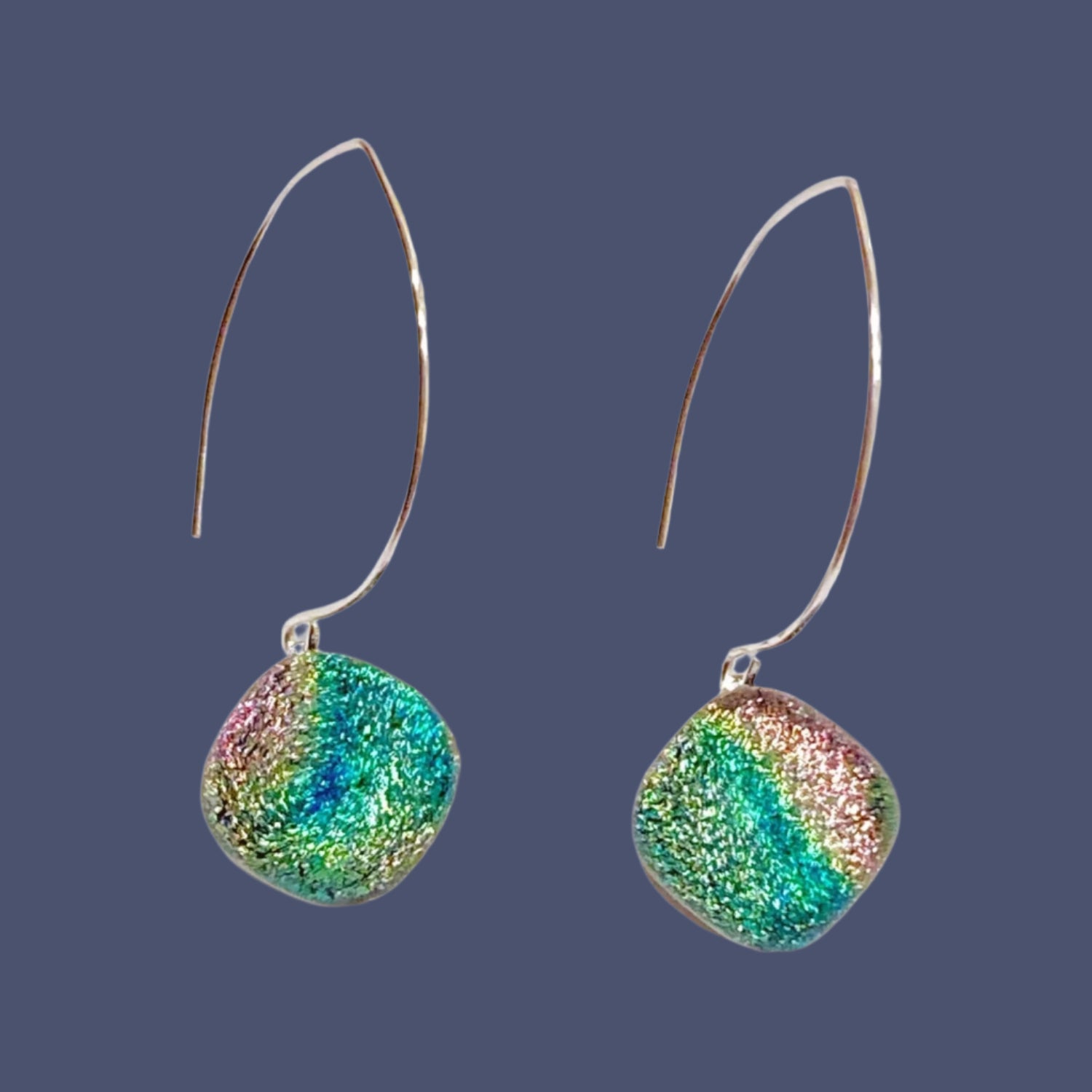A pair of long earrings with fused glass dangles, by 3D Glass Designs.