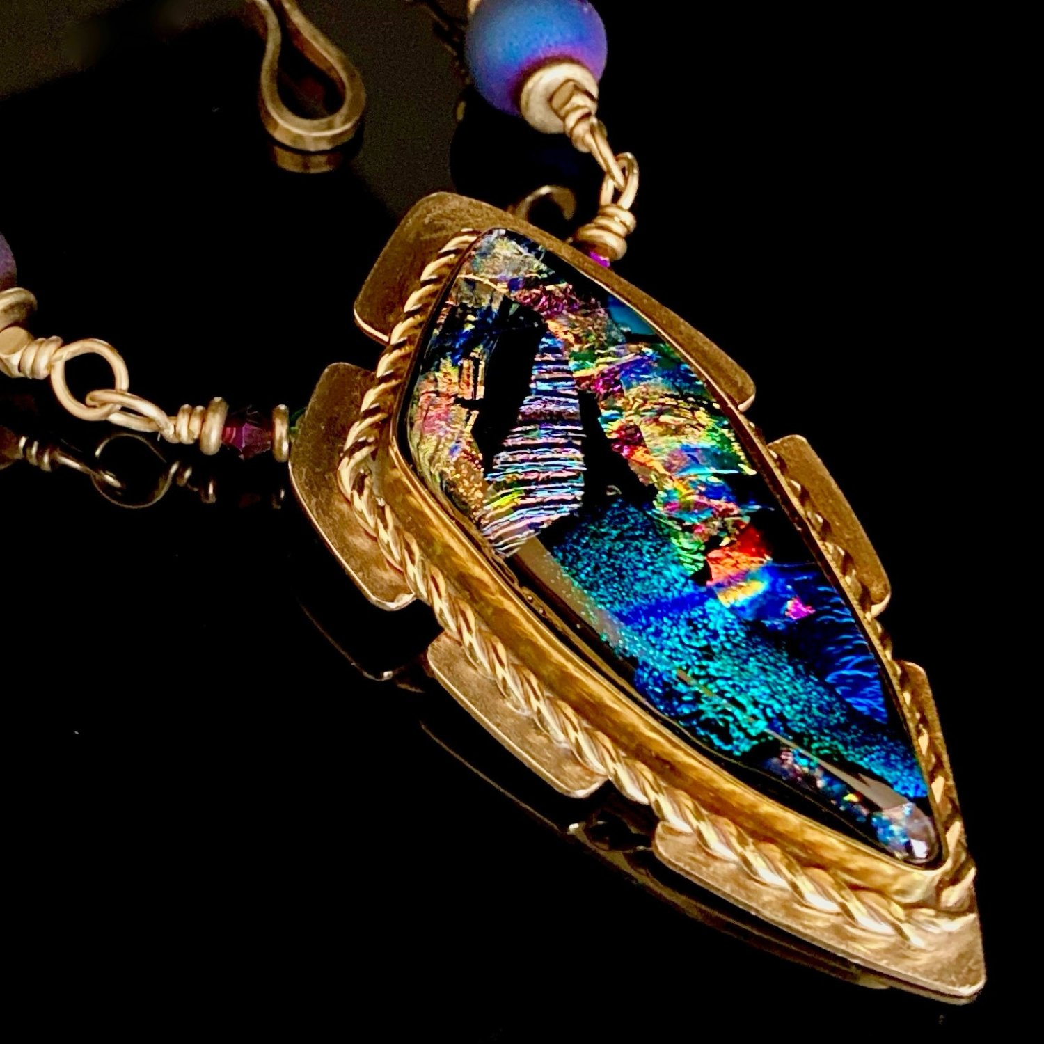 Multicolor handcrafted dichroic glass pendant set in brass, with a handmade beaded chain. By 3D Glass Designs.
