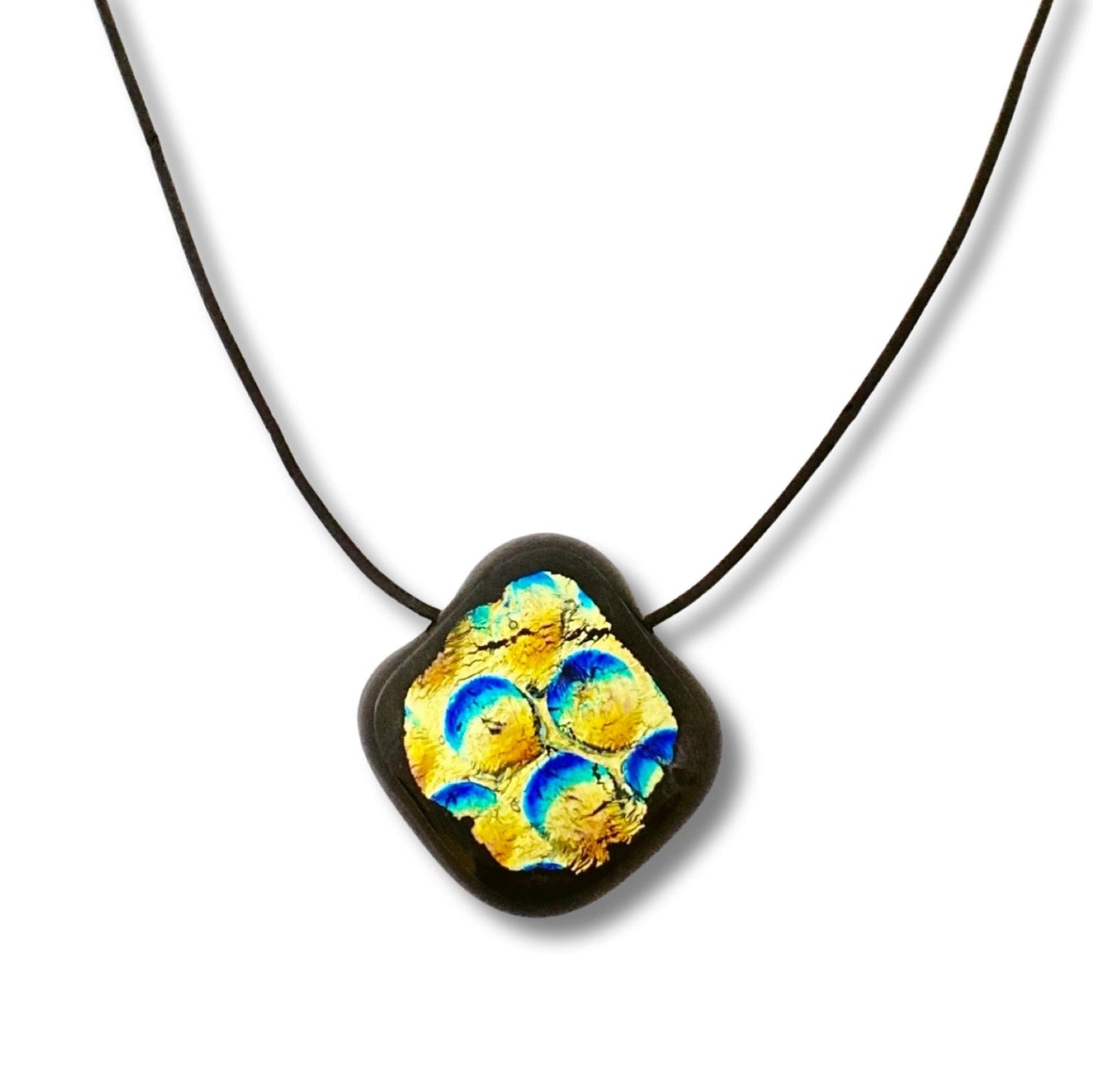 Small blue, gold and black glass pendant against a white background, by 3D Glass Designs.