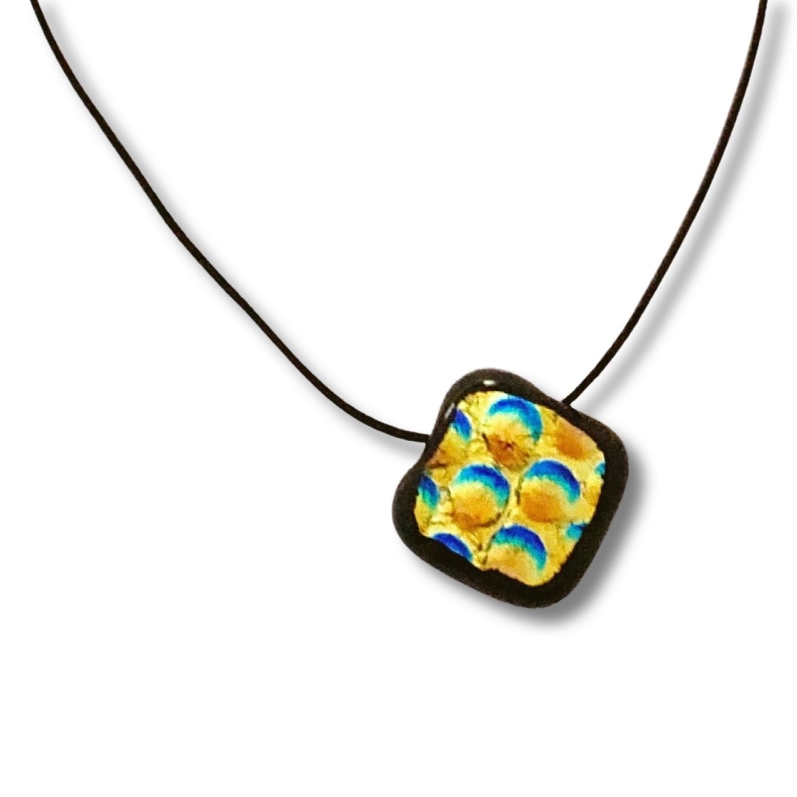 Fused glass pendant against a white background, by 3D Glass Designs.
