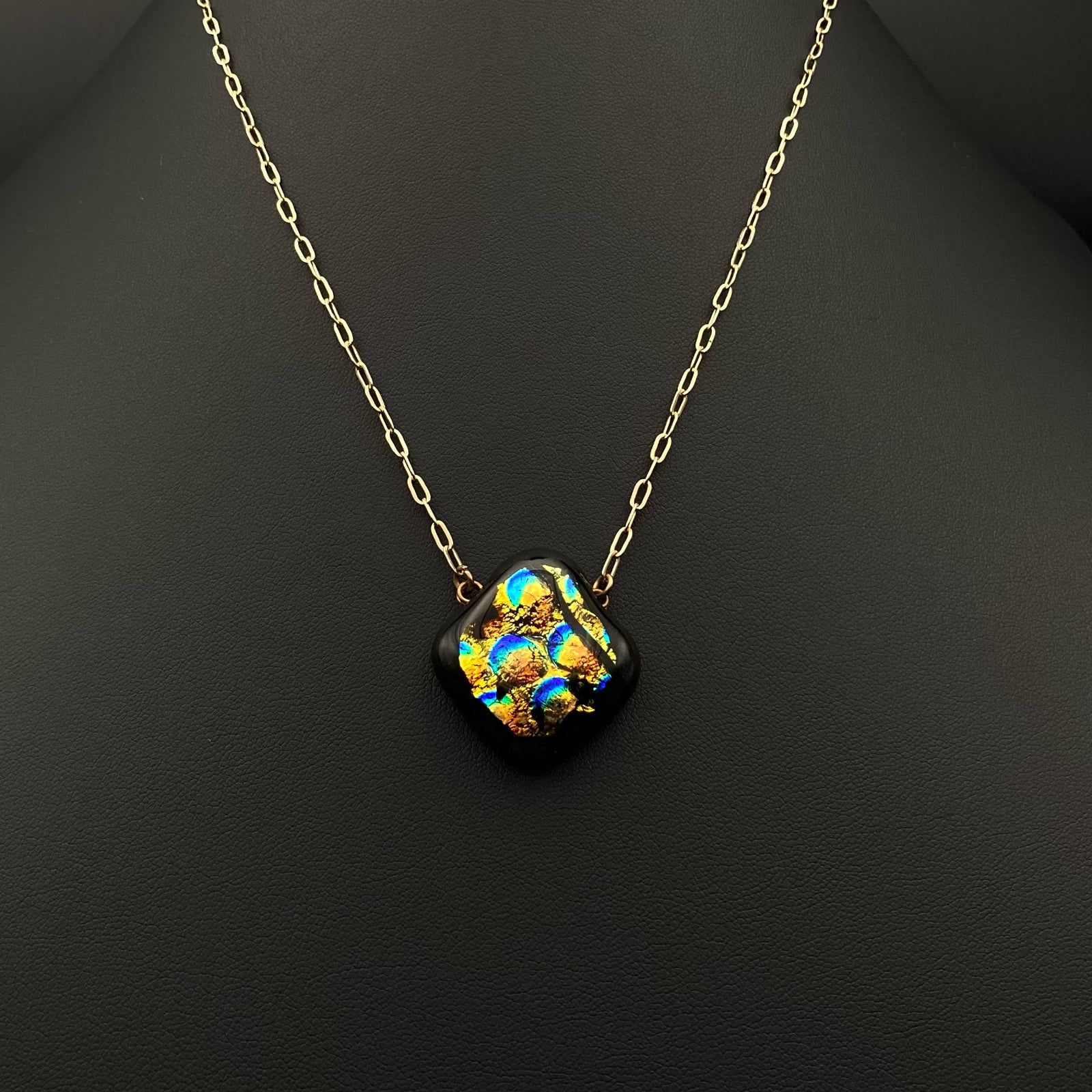 Dichroic glass necklace on a black background, by3D Glass Designs.