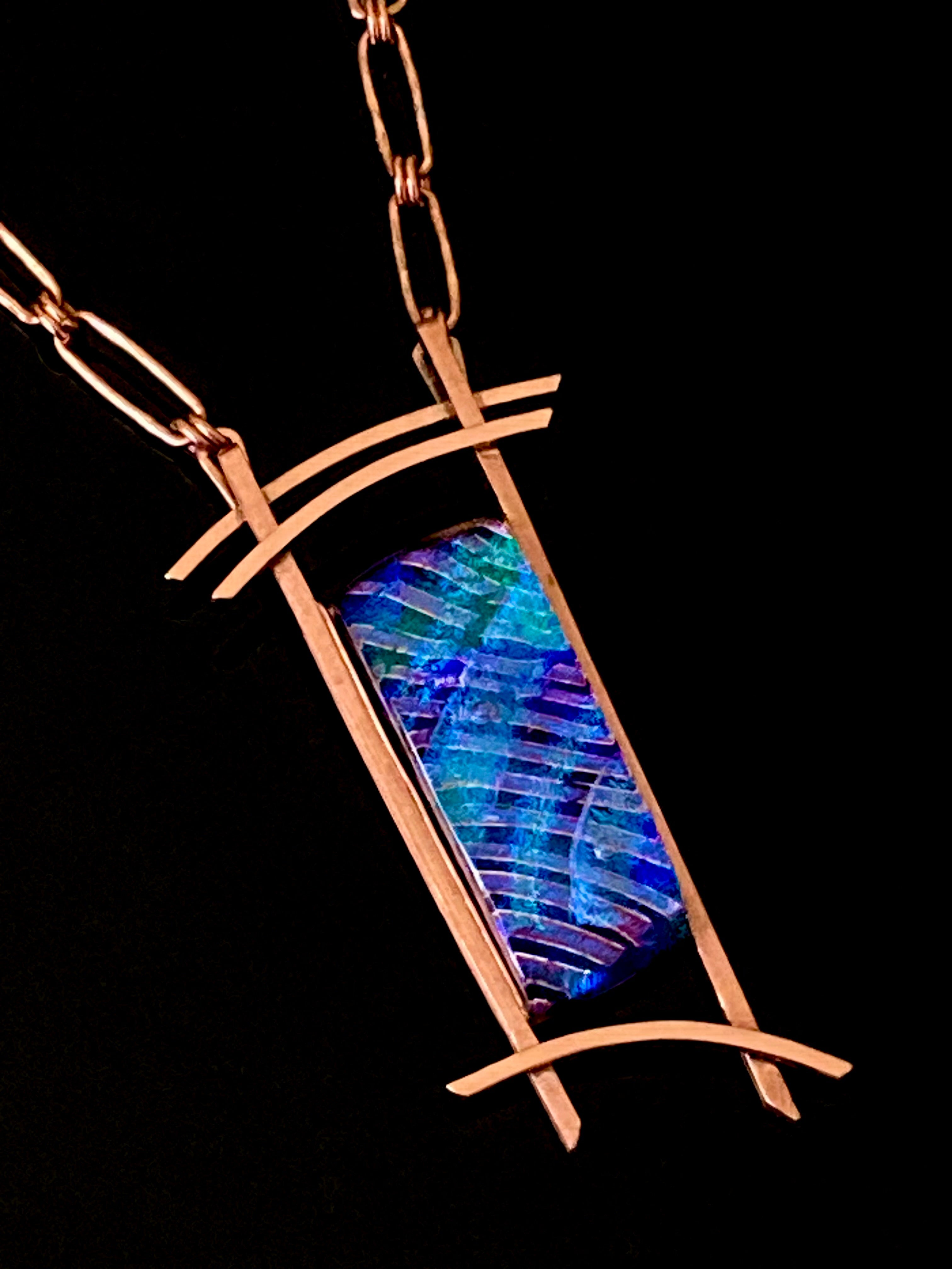Blue dichroic glass set in a handcrafted copper pendant with an Asian design. Handmade copper paperclip link chain completes the design, by 3D Glass Designs