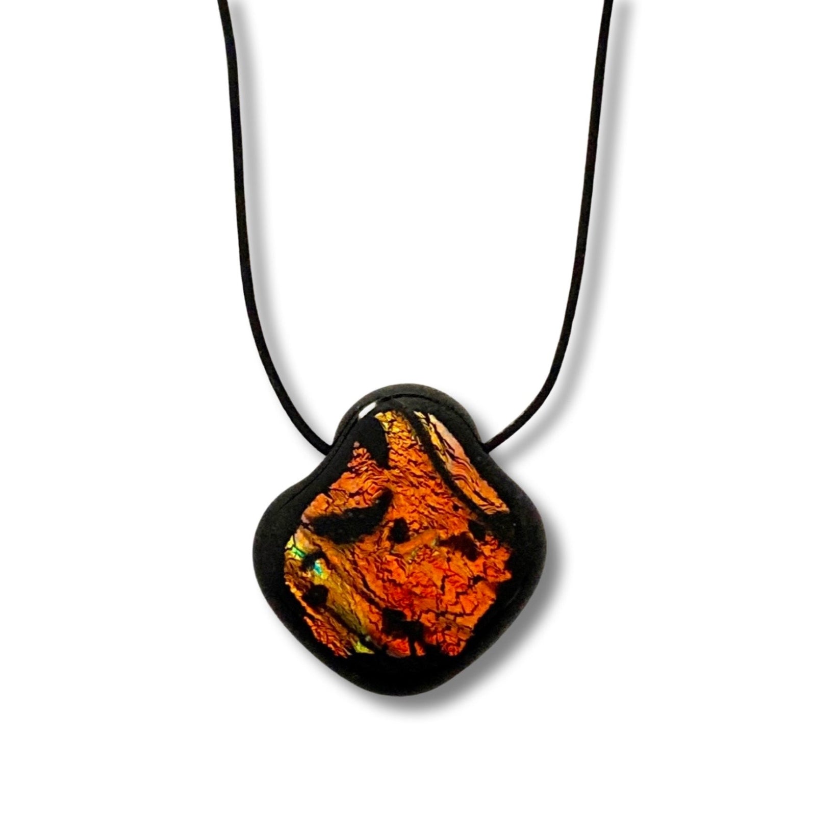 Orange and black pendant on a black leather cord against a white background, by 3D Glass Designs.