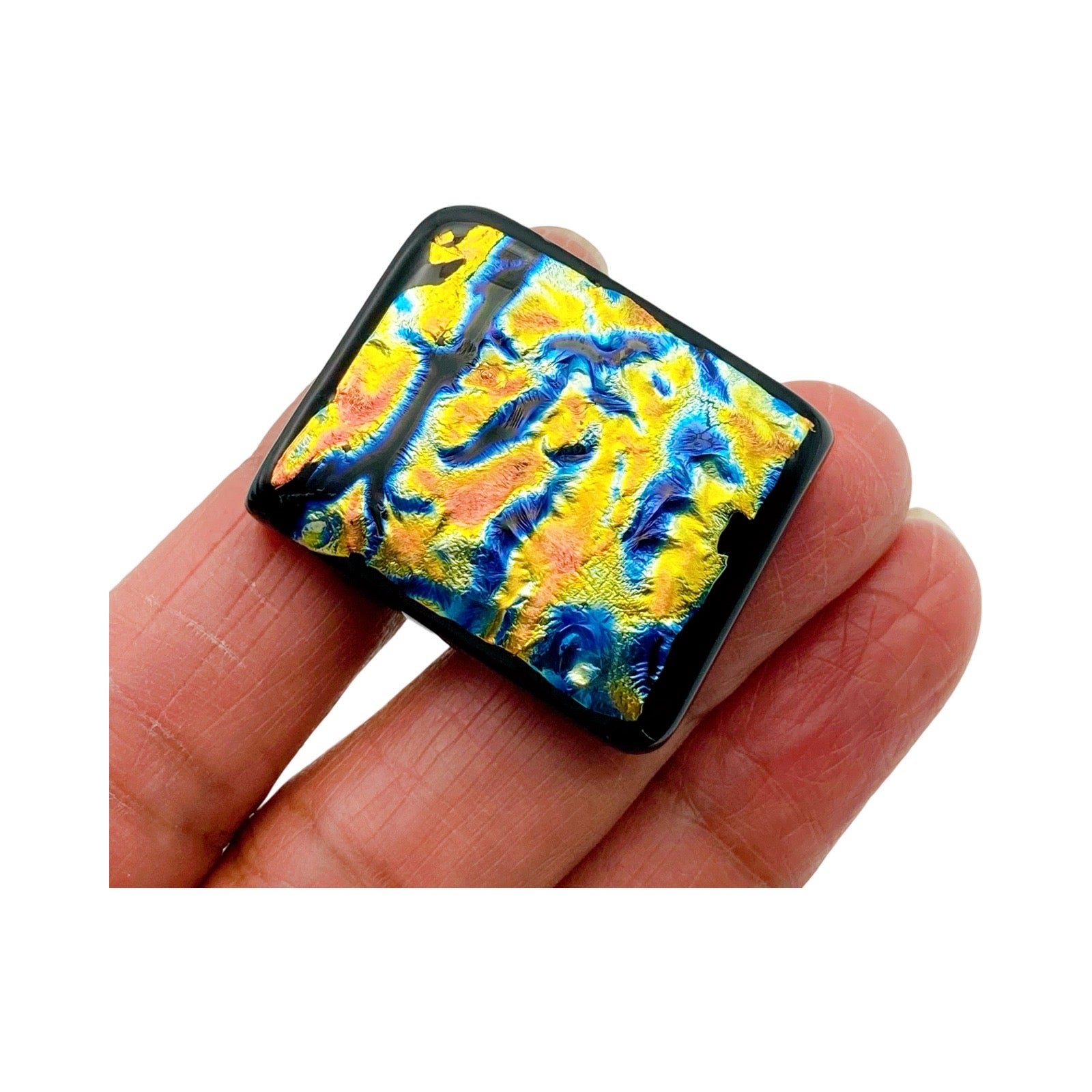 Hand holding handmade dichroic glass furniture knob, 3D Glass Designs.