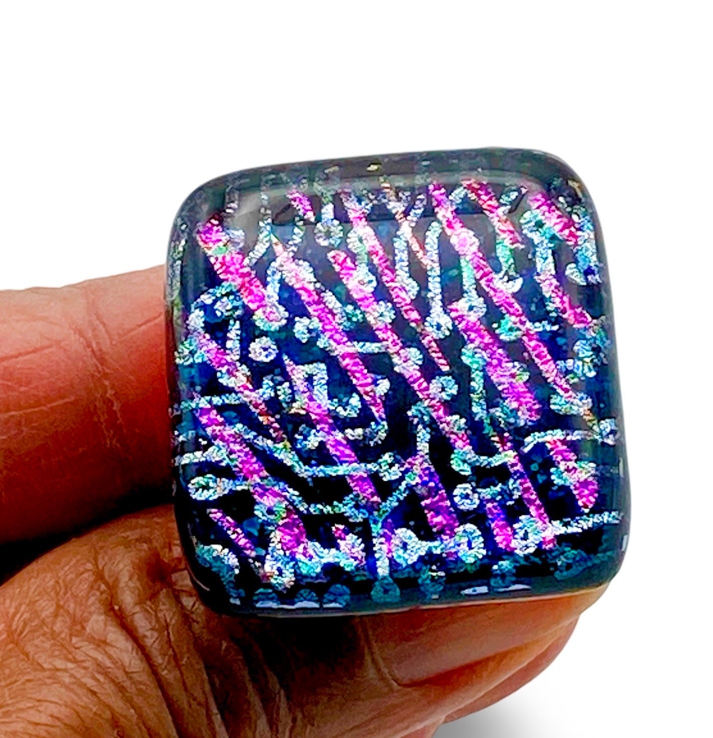 Hand holding handcrafted fused glass furniture knob, by 3D Glass Designs.