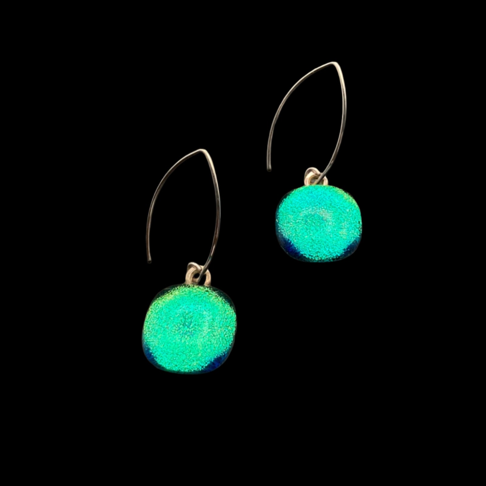 A pair of round glass earrings with silver ear wires against a black background, by 3D Glass Designs.