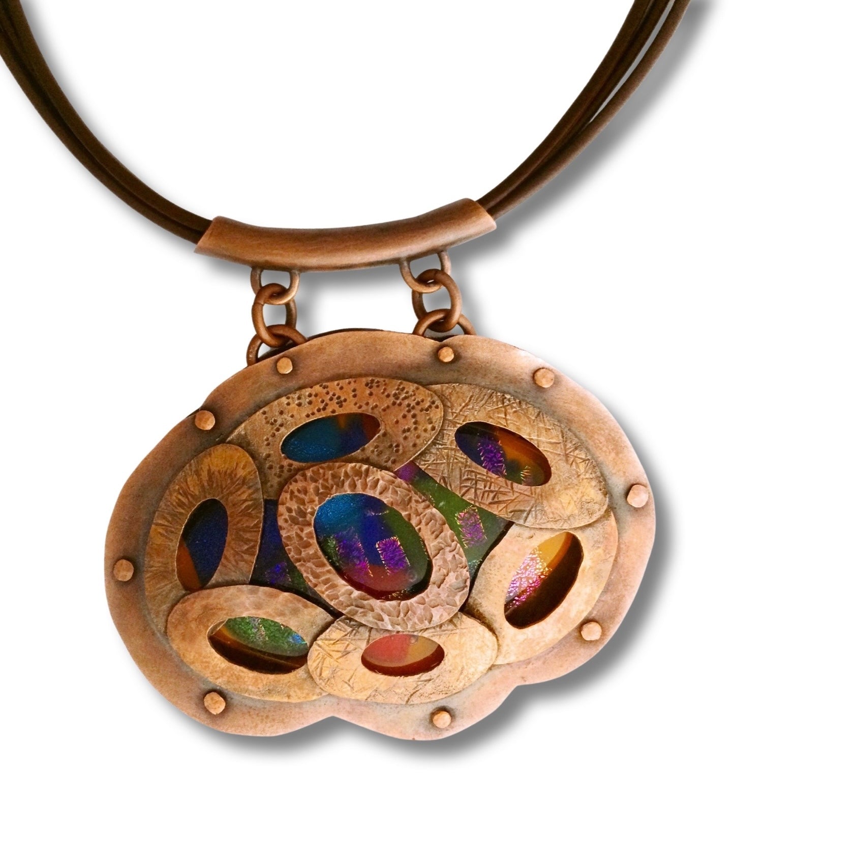Artisan designed copper and fused glass pendant, oval shaped with overlapping copper ovals on top, revealing colorful glass beneath. By 3D Glass Designs