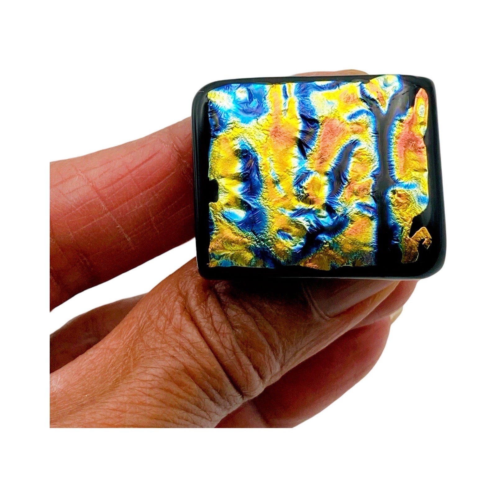 Hand holding handmade dichroic glass furniture knob, 3D Glass Designs.