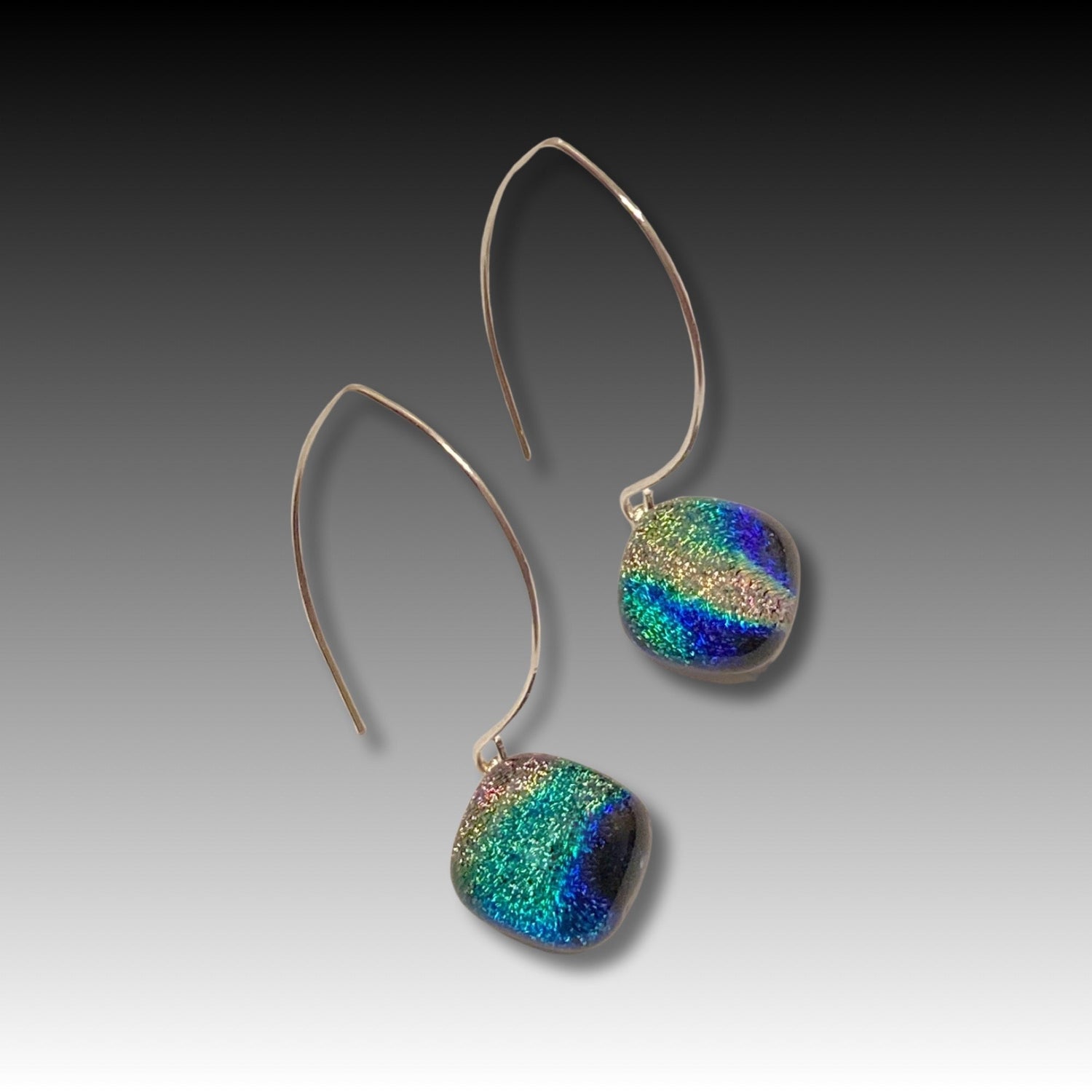 A pair of pierced earrings with a dichroic glass drop, by 3D Glass Designs