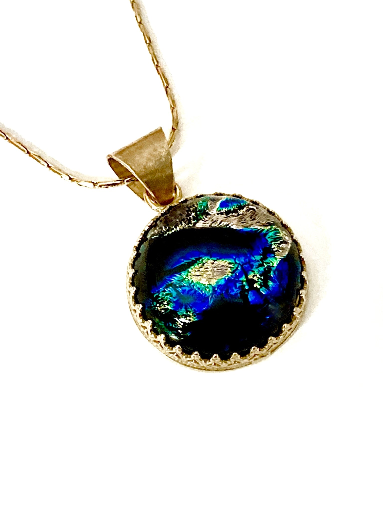 Small handmade fused glass round pendant set in brass. By 3D Glass Designs.
