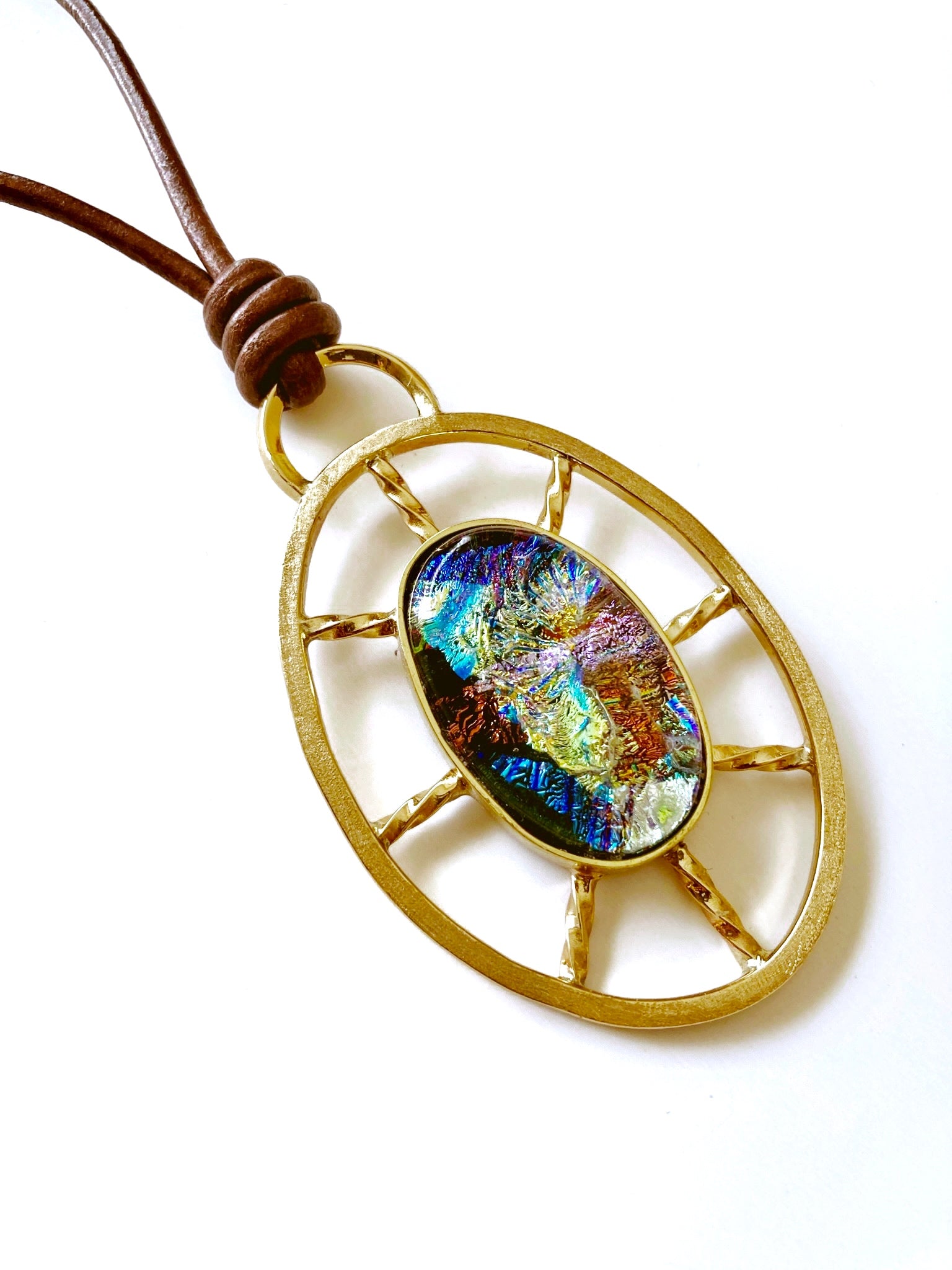 Nautical inspired multicolor dichroic glass set in a brass oval wheel shaped design, by 3D Glass Designs.