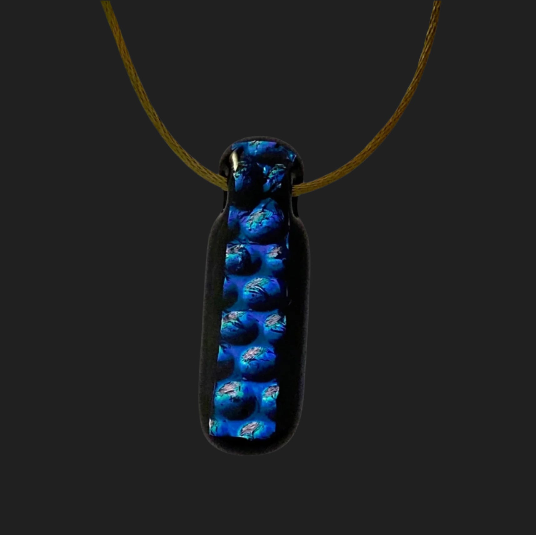 Blue and black glass pendant hanging from a satin cord, by 3D Glass Designs.