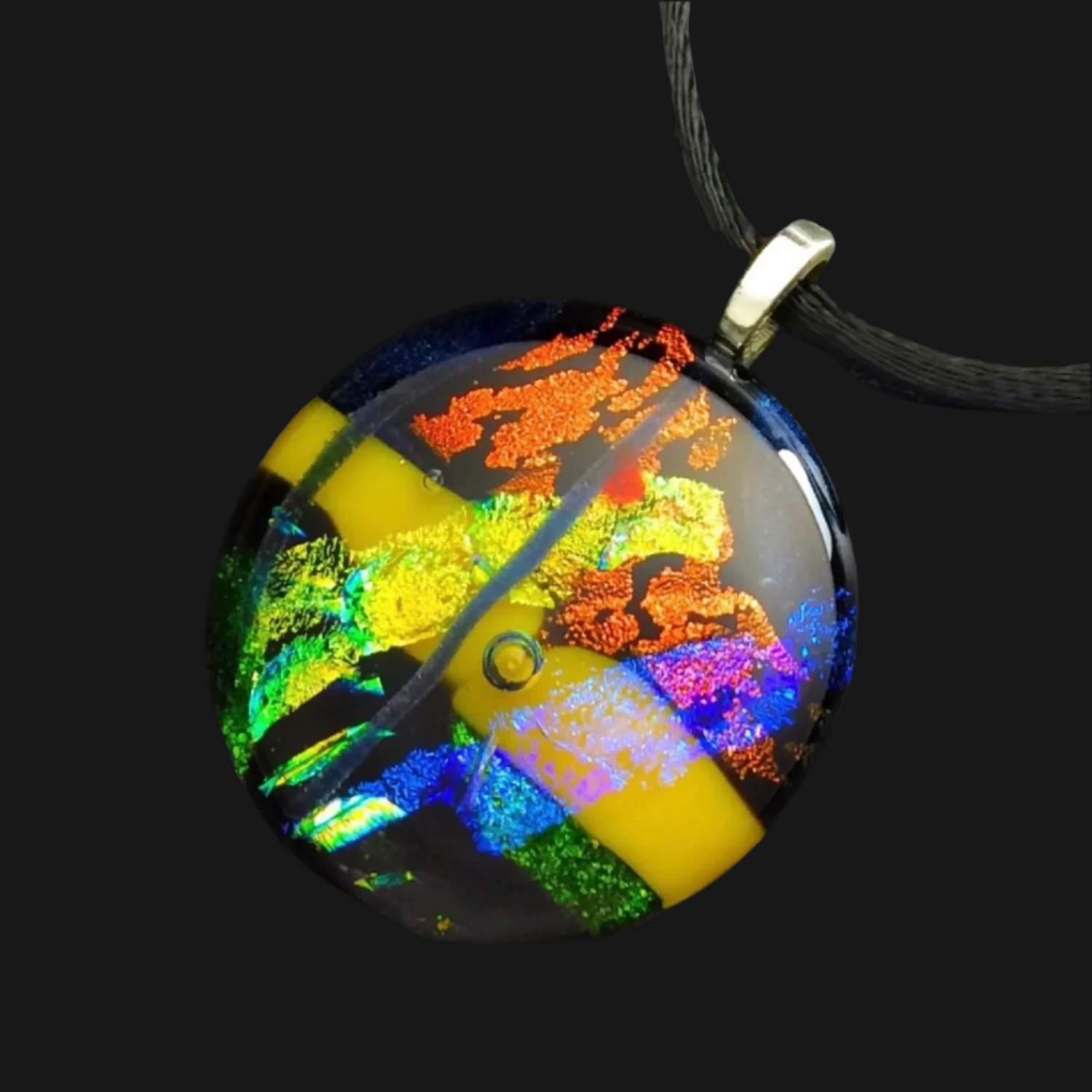 Fused glass round pendant necklace in green, yellow, blue, and rust hung on a 16-inch satin cord, by 3D Glass Designs