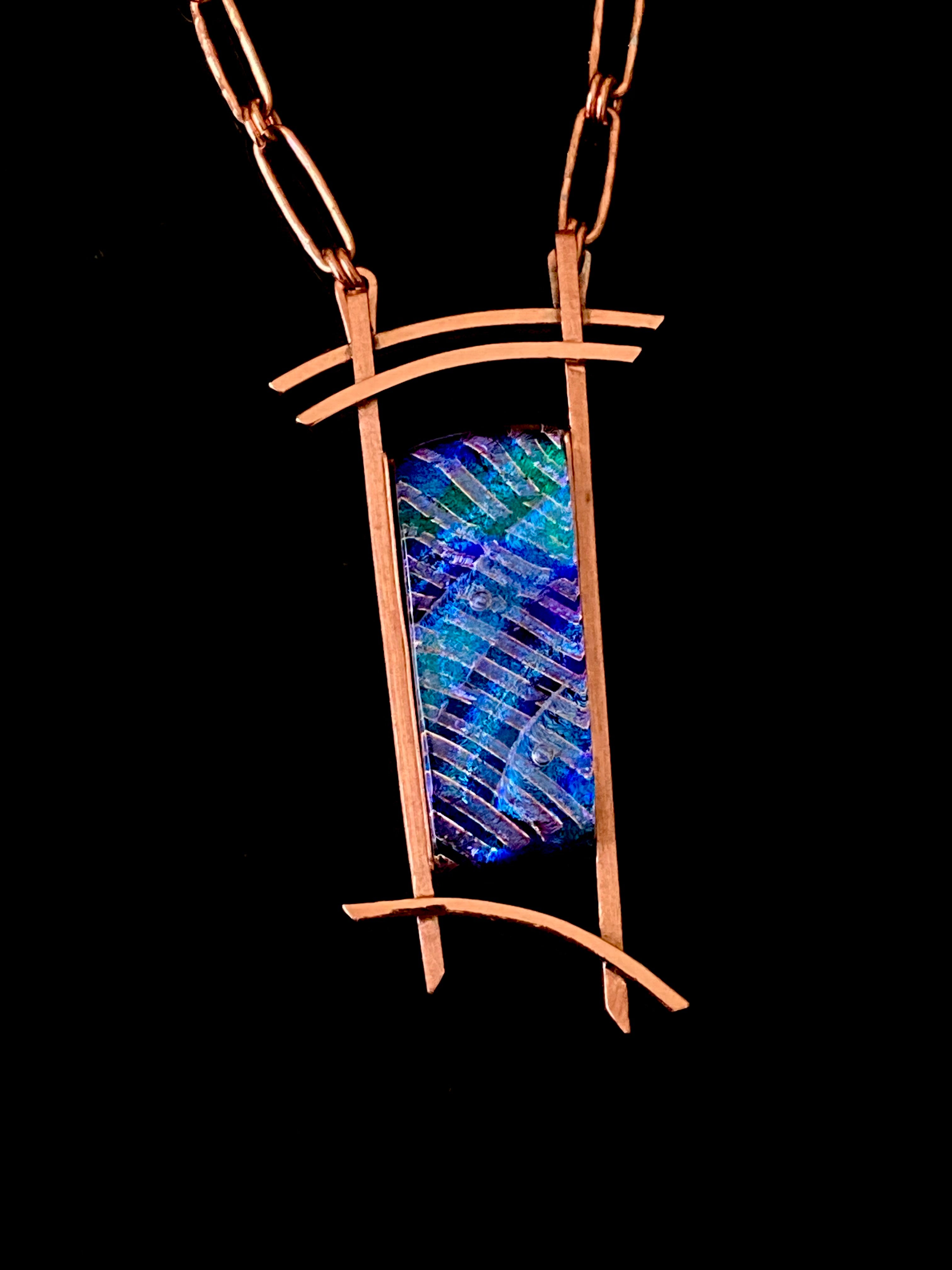 Blue dichroic glass set in a handcrafted copper pendant with an Asian design. Handmade copper paperclip link chain completes the design, by 3D Glass Designs