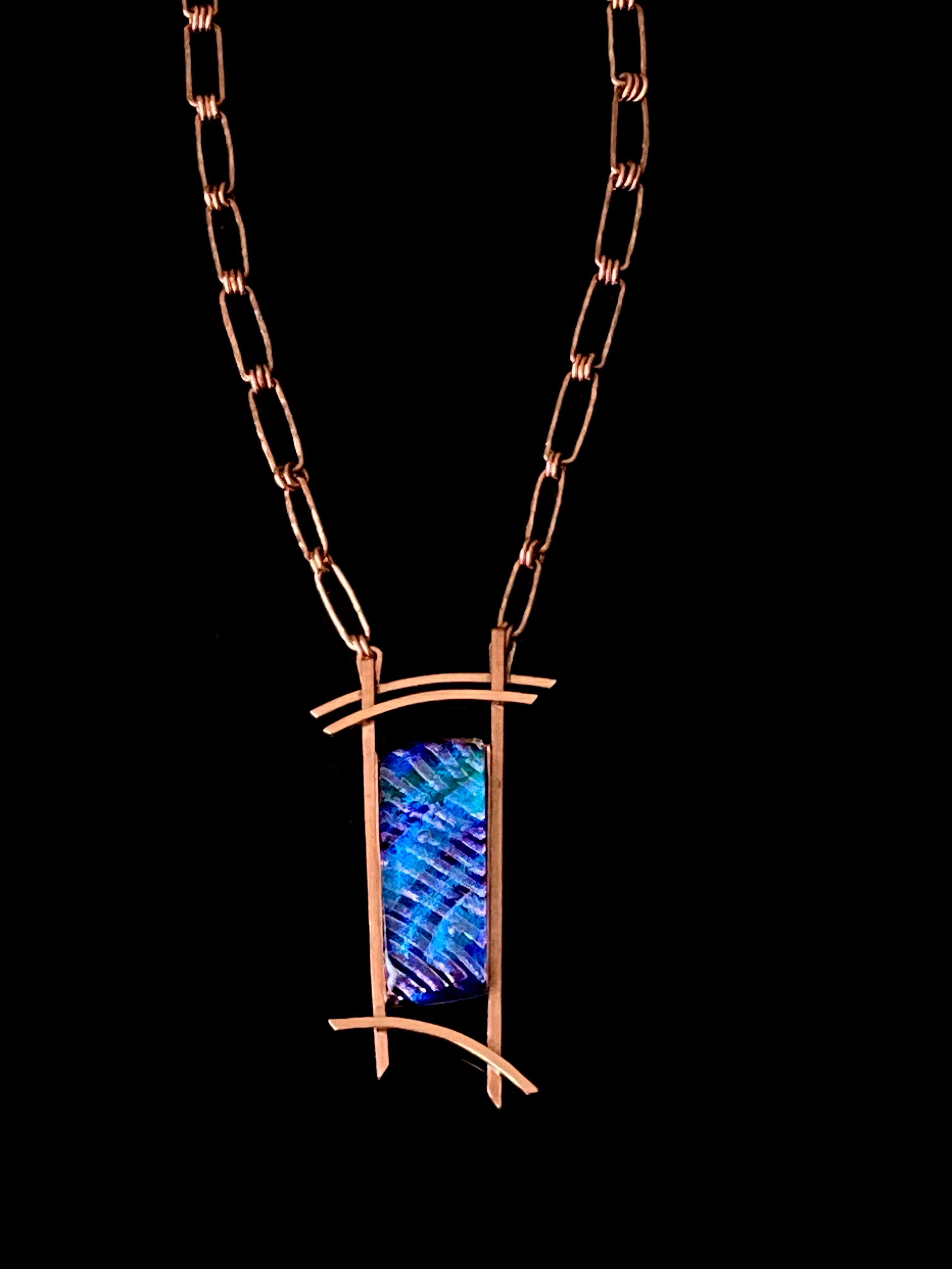 Blue dichroic glass set in a handcrafted copper pendant with an Asian design. Handmade copper paperclip link chain completes the design, by 3D Glass Designs