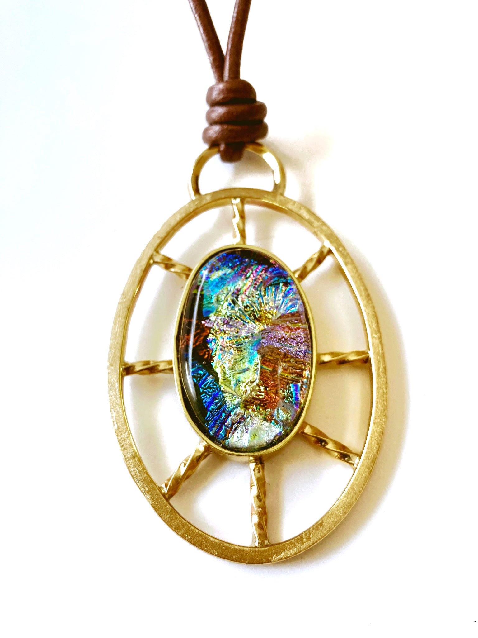 Nautical inspired multicolor dichroic glass set in a brass oval wheel shaped design, by 3D Glass Designs.