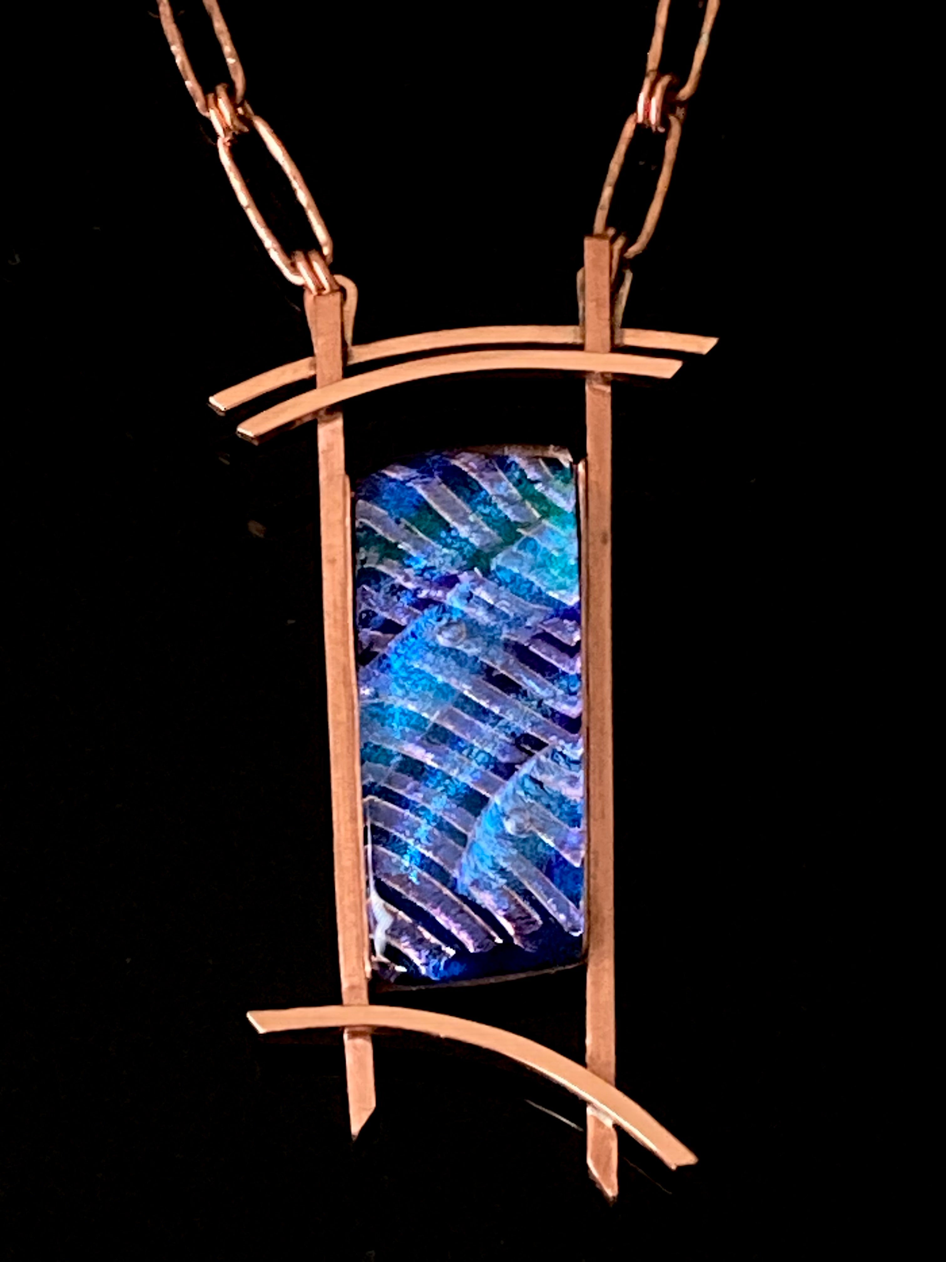 Blue dichroic glass set in a handcrafted copper pendant with an Asian design. Handmade copper paperclip link chain completes the design, by 3D Glass Designs