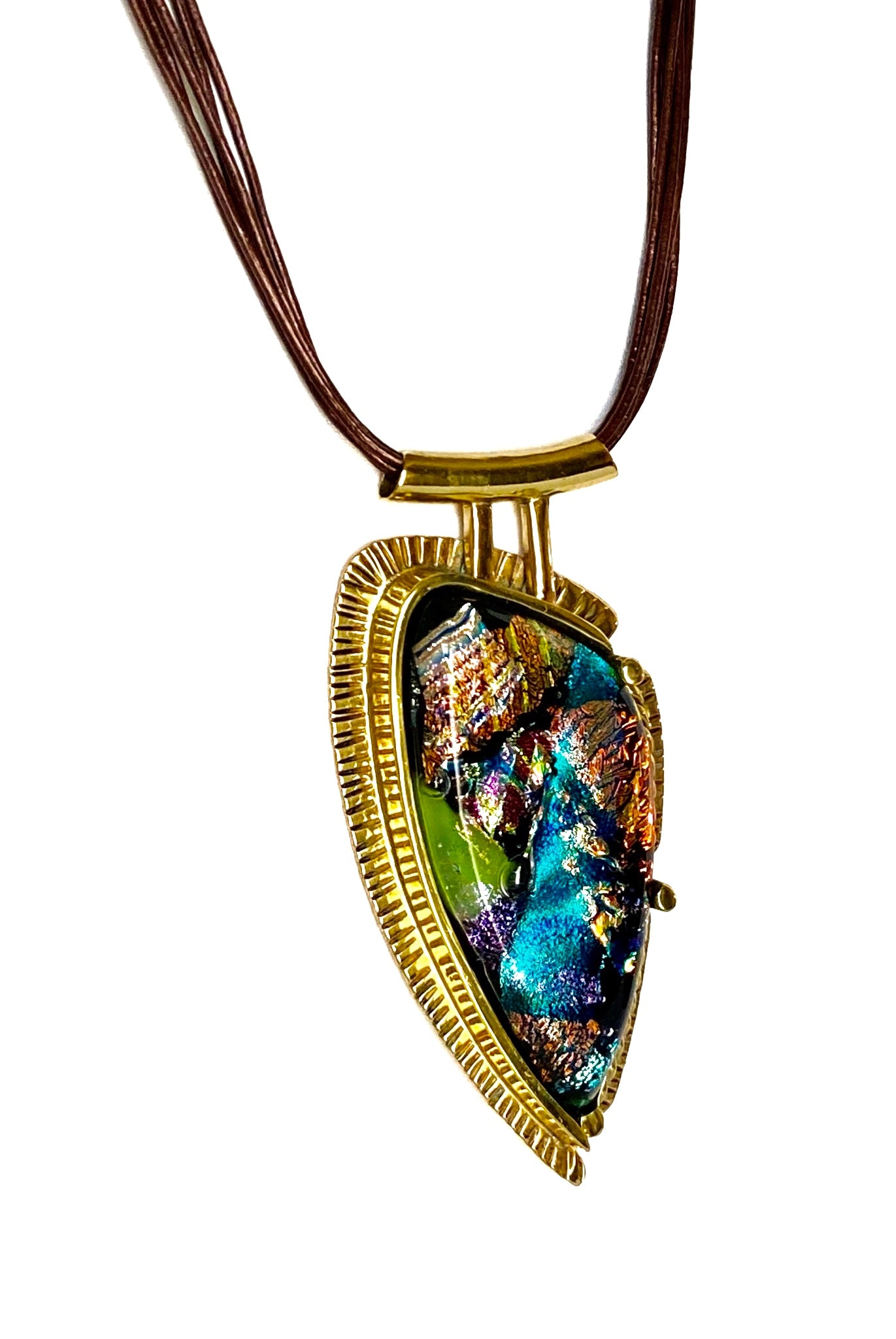 Handcrafted brass pendant featuring multicolored dichroic glass in a shield-shape hung on a multistrand leather necklace, by 3D Glass Designs.