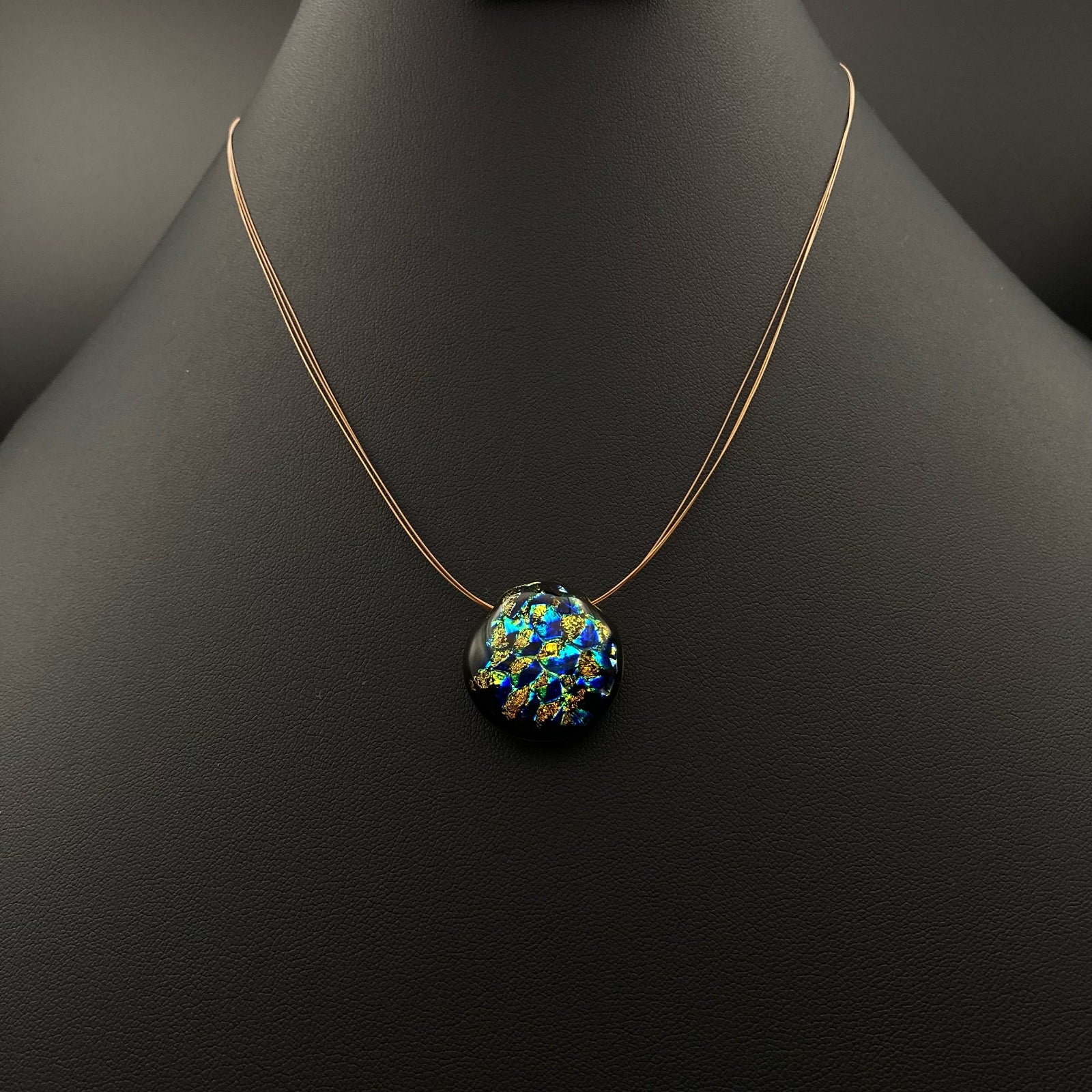 Small round glass pendant on a three-strand necklace, by 3D Glass Designs.