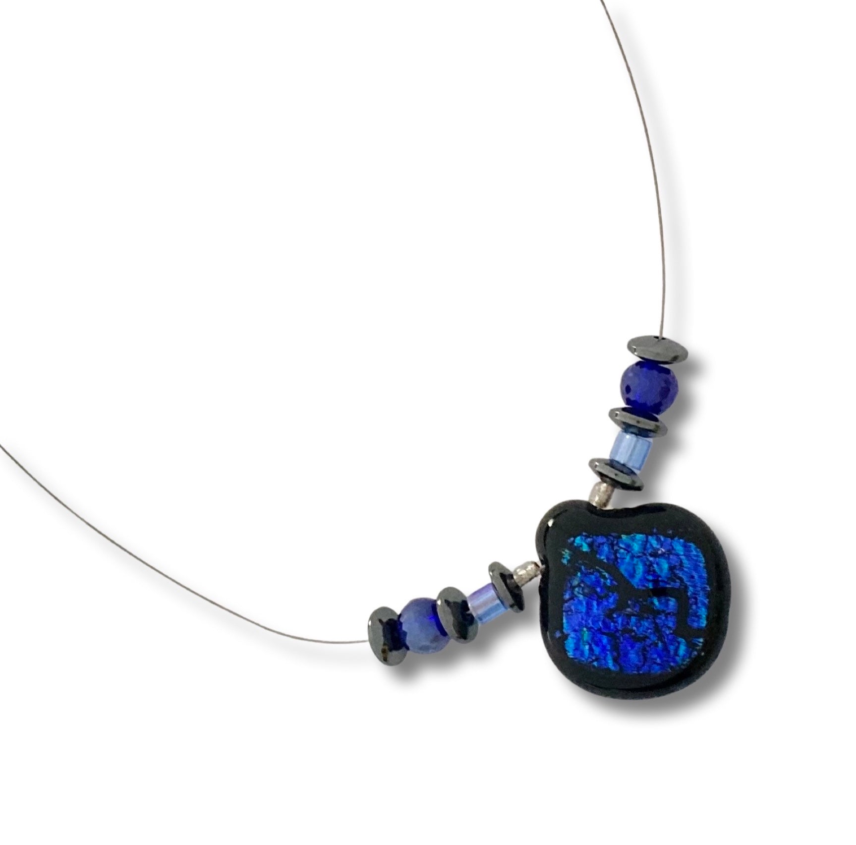 Handmade floating beaded necklace against a white background, by 3D Glass Designs.