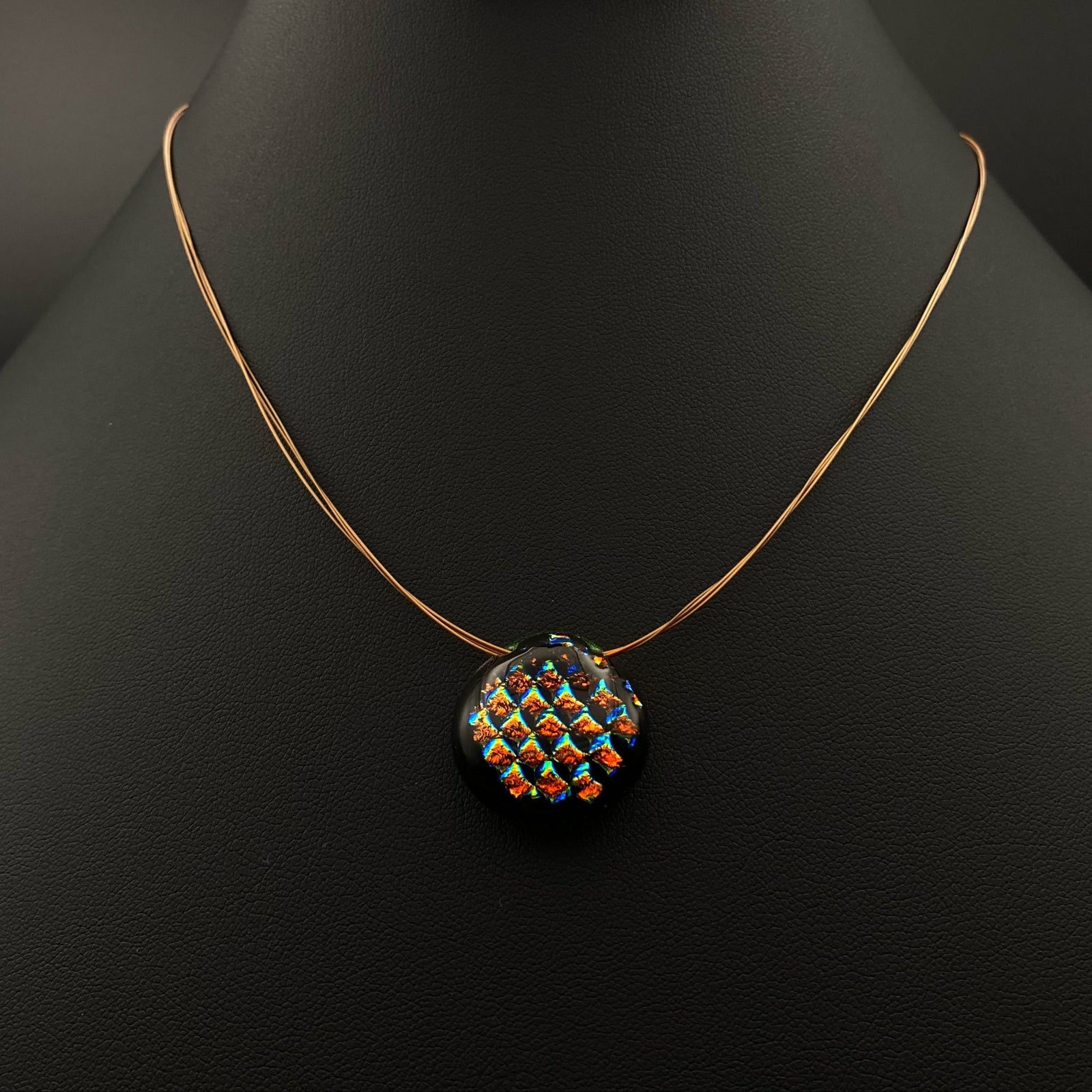 Multi-color round pendant on a three-strand necklace, by 3D Glass Designs.