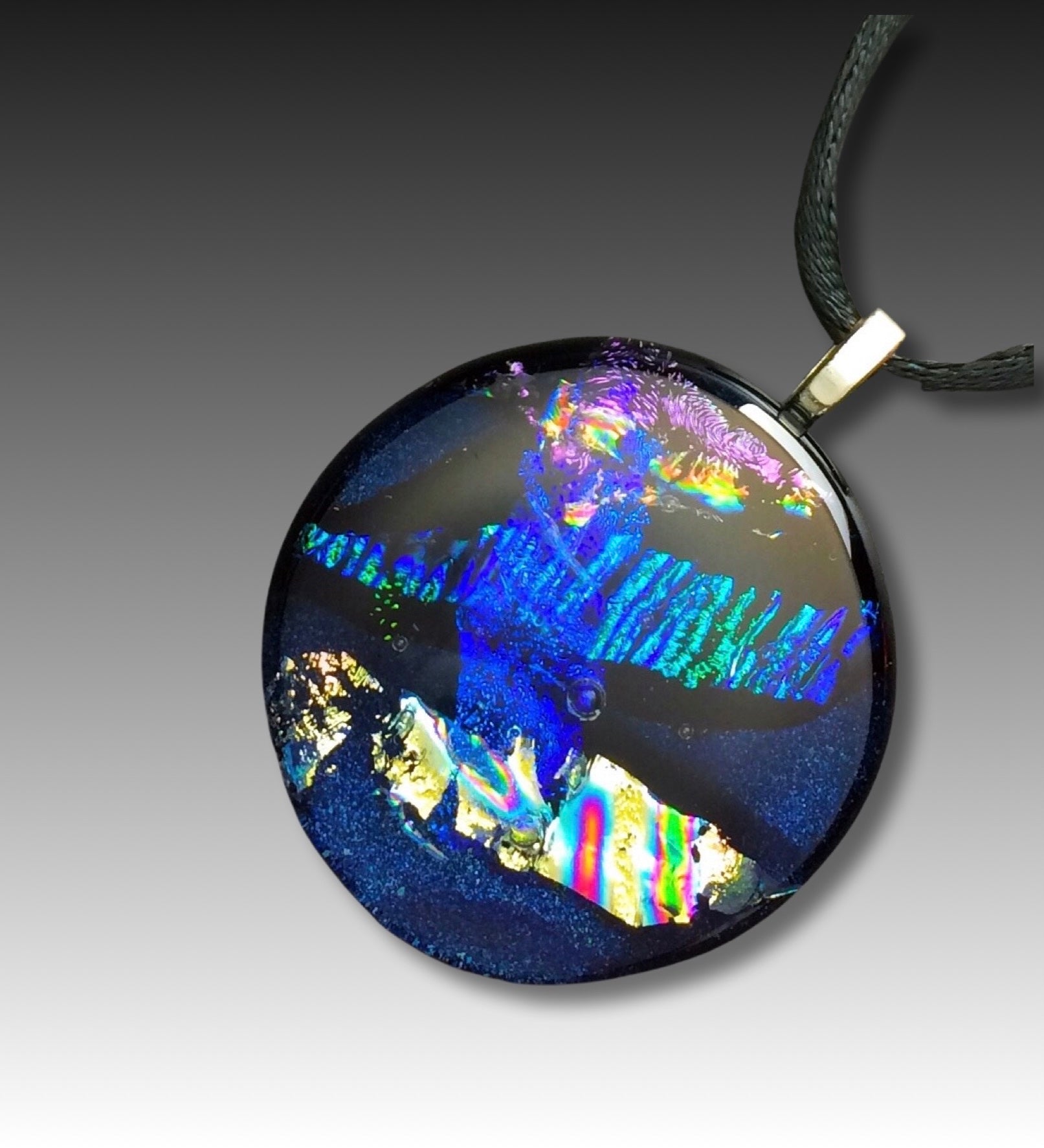 Round dichroic glass pendant in midnight blue, purple, silver and teal, by 3DGlass Designs.
