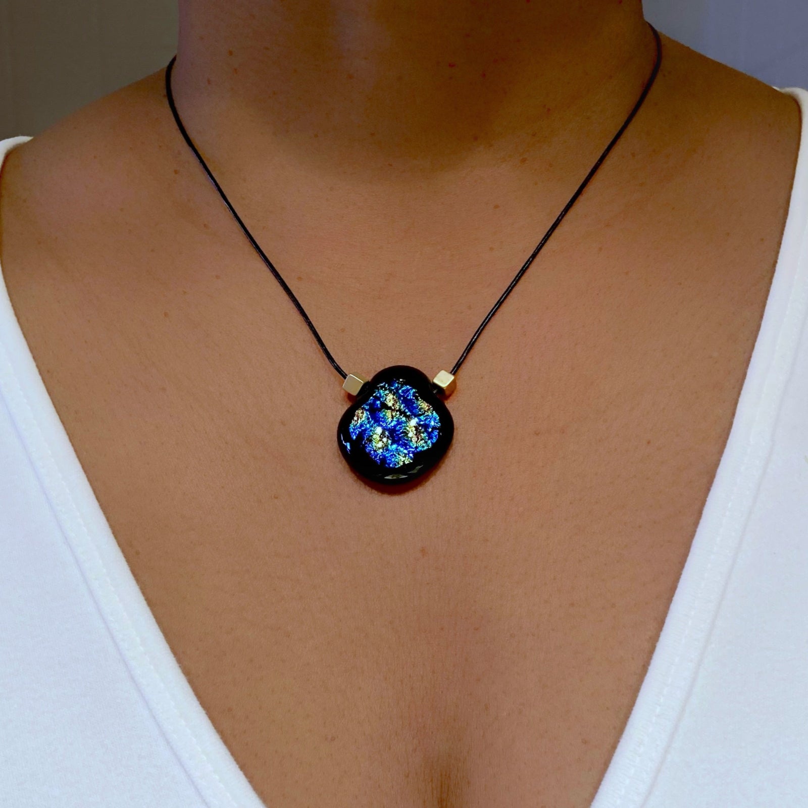 Model wearing fused glass pendant in a white tee shirt, by 3D Glass Designs.