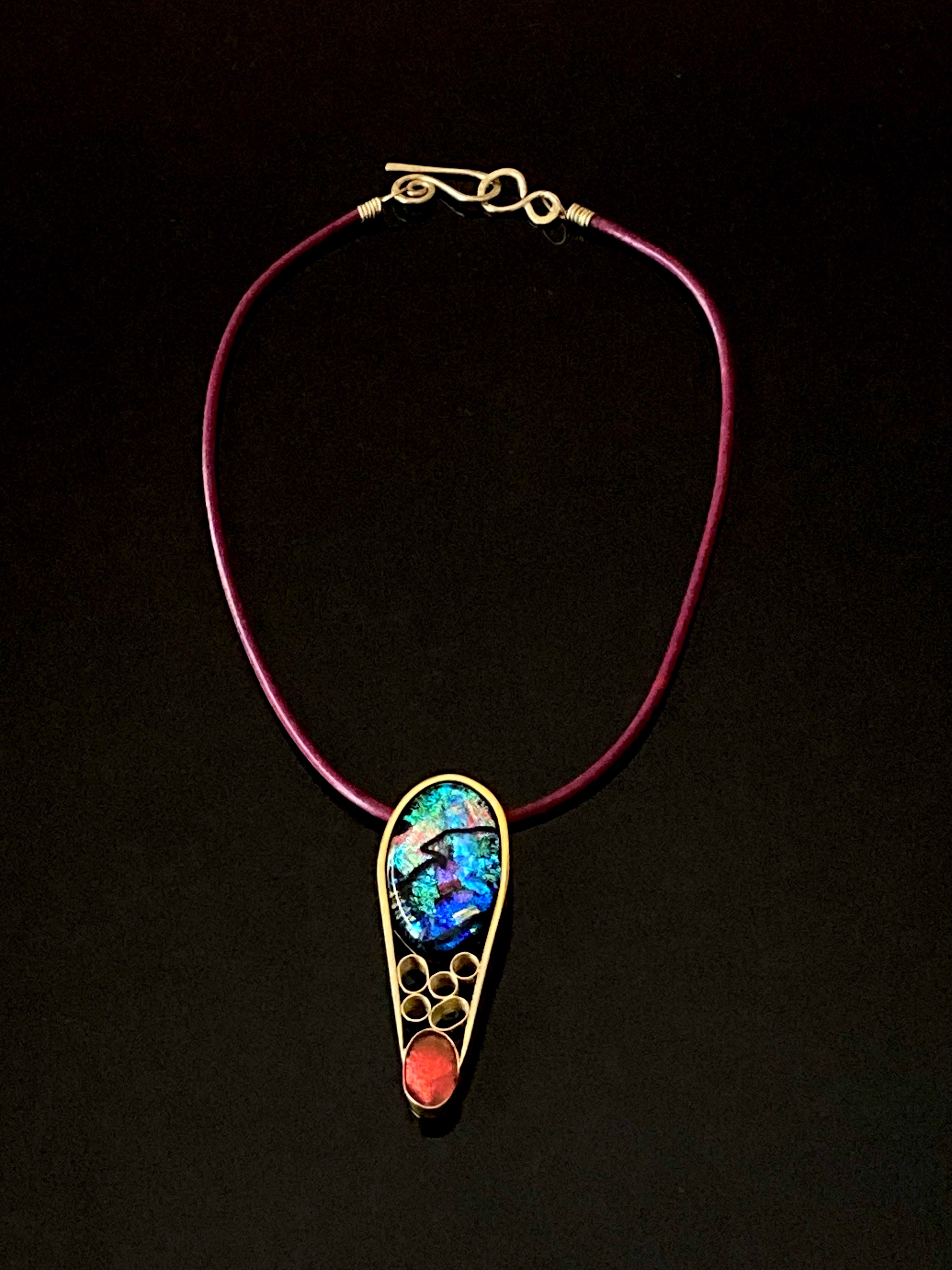 Contemporary dichroic glass and bass pendant with burgundy leather cord, handmade by 3D Glass Designs.
