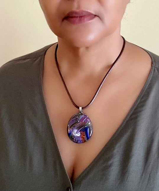 Model wearing fused dichroic glass pendant with a unique handblown glass design. By 3D Glass Designs