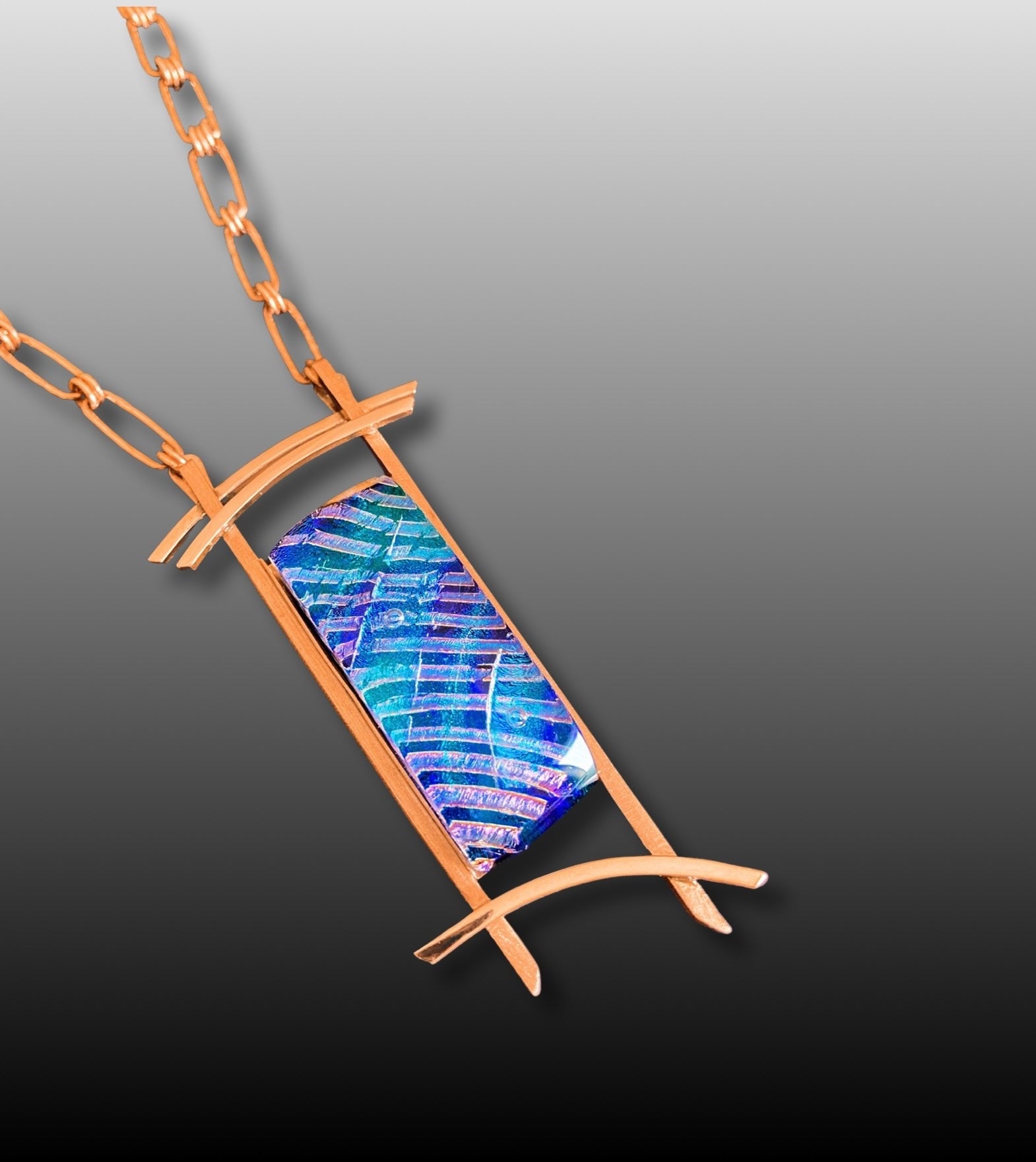 Handmade fused glass in blues set in a handcrafted copper pendant with a handmade copper chain, by 3D Glass Designs.