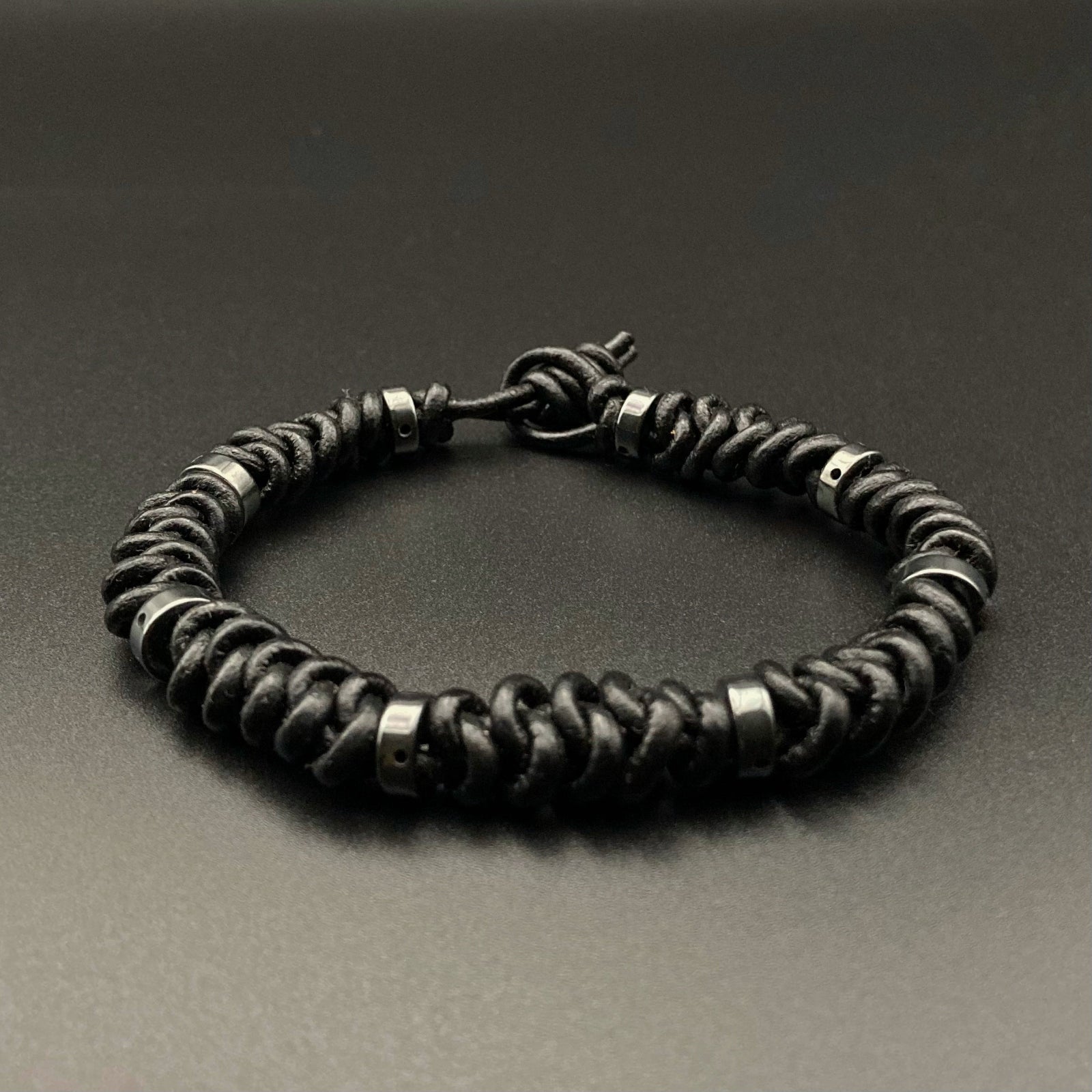 Black leather macrame bracelet with hematite beads, by 3D Glass Designs.