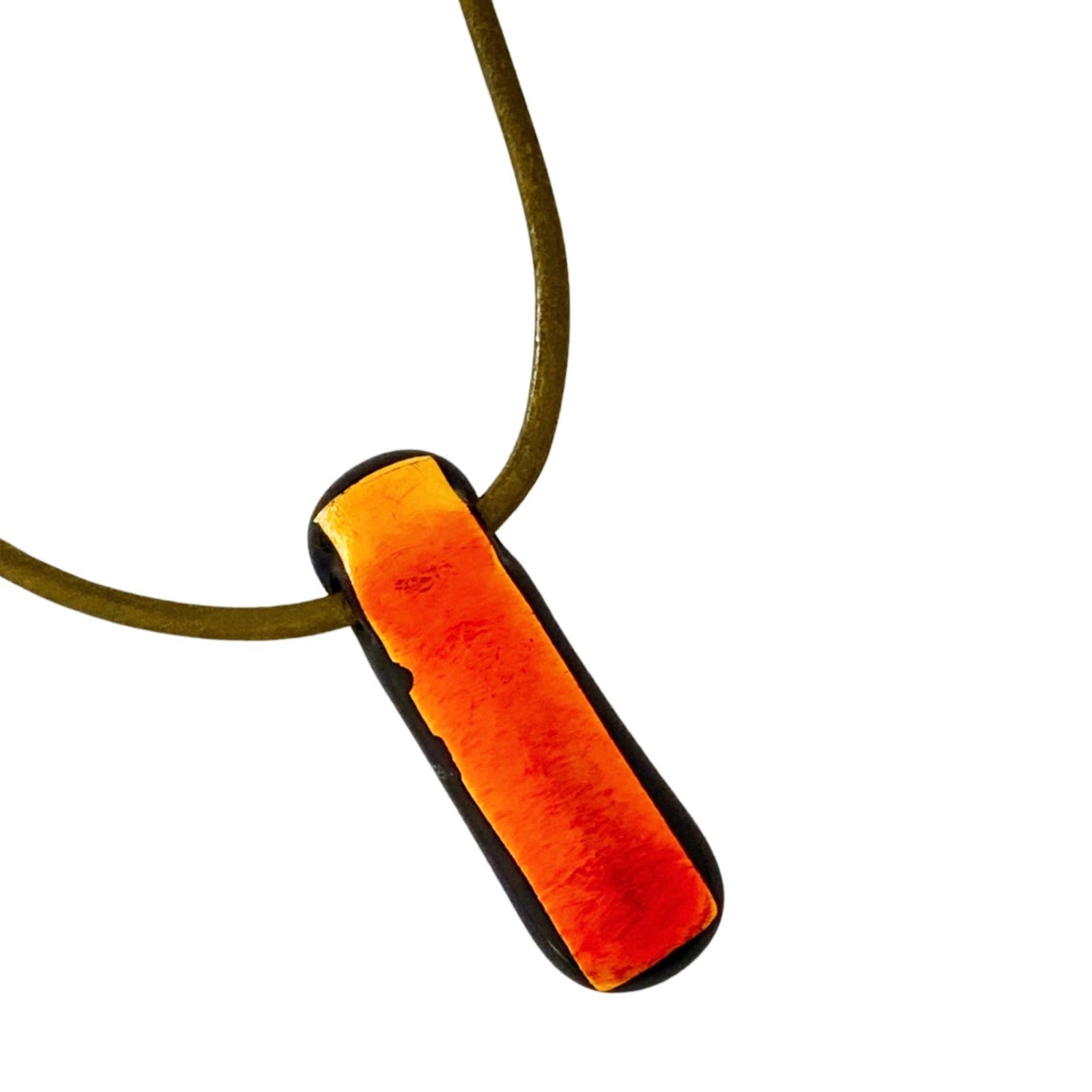 Red fused glass pendant against a white background, by 3D Glass Designs.