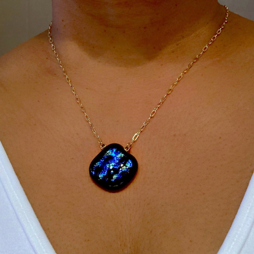 Model wearing glass pendant on a delicate gold chain, by 3D Glass Designs.