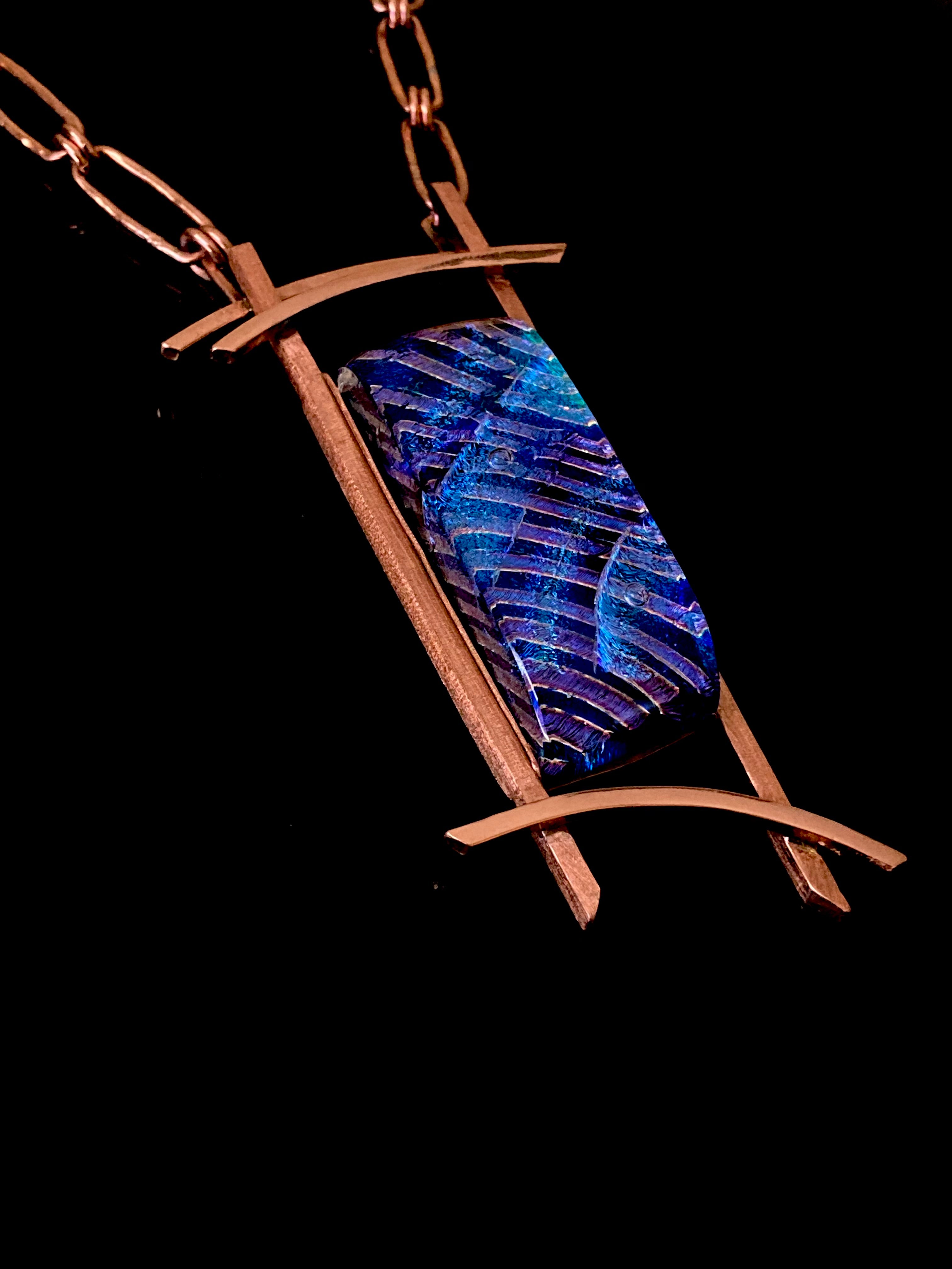 Blue dichroic glass set in a handcrafted copper pendant with an Asian design. Handmade copper paperclip link chain completes the design, by 3D Glass Designs