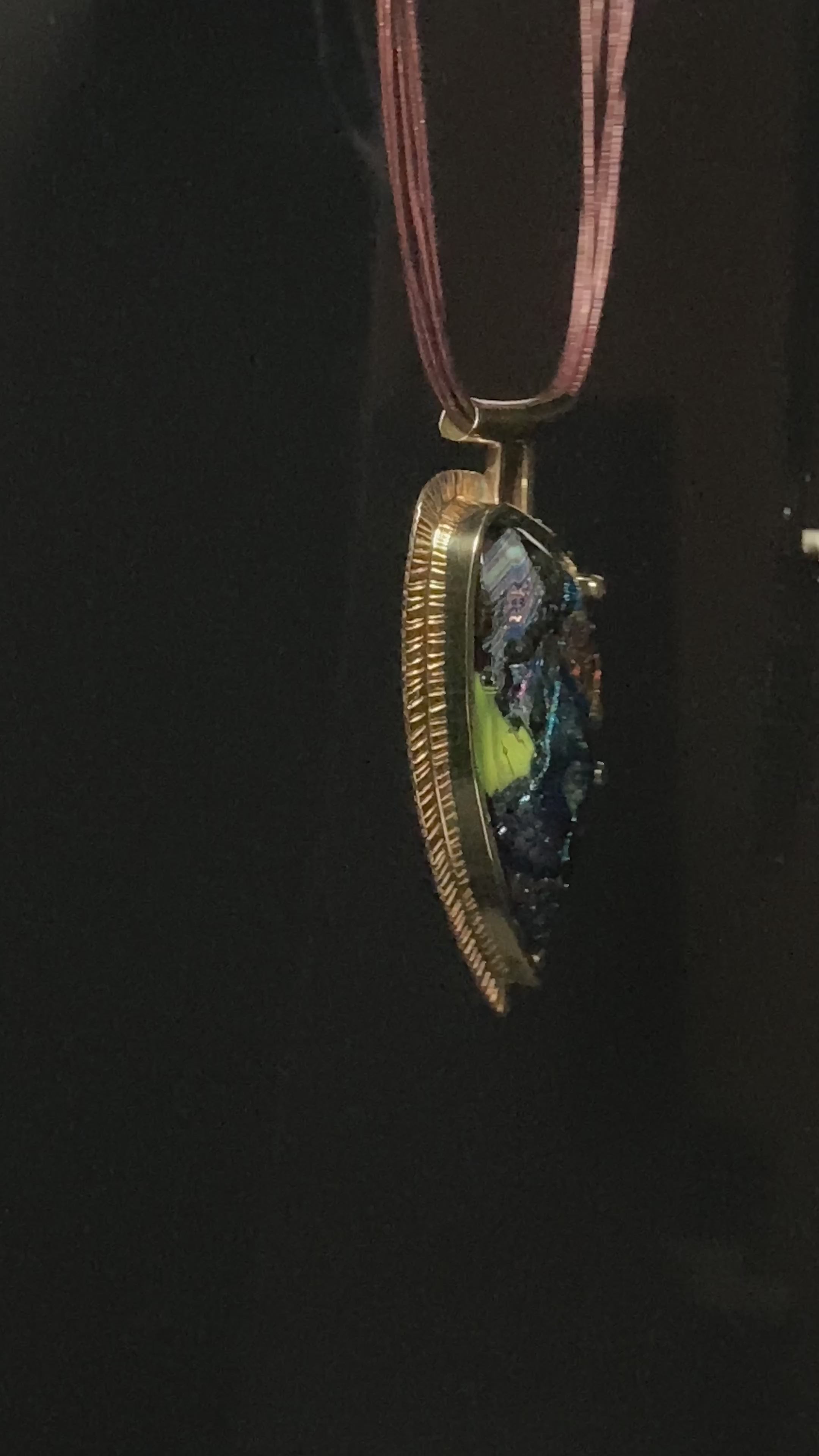Video of handcrafted multicolor fused glass set in brass on a multistrand leather necklace, by 3D Glass Designs.