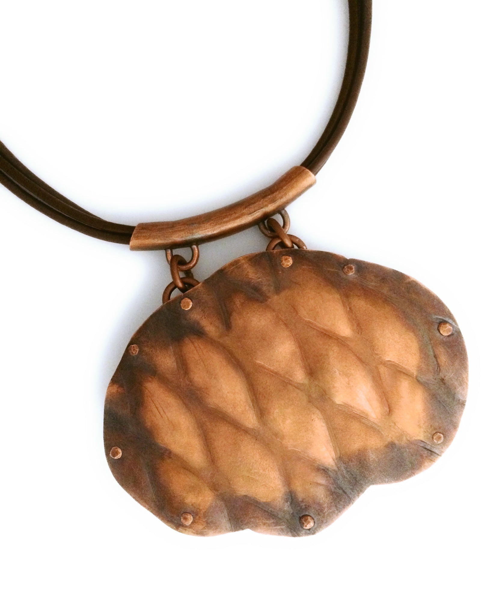 Back of artisan designed copper and fused glass pendant, oval shaped with overlapping copper ovals on top, revealing colorful glass beneath. By 3D Glass Designs