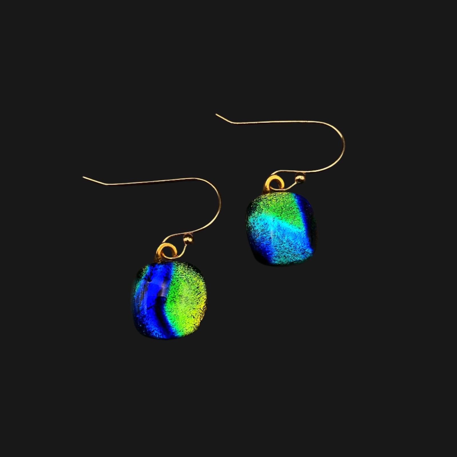 A pair of pierced earrings on a dark grey background, by 3D Glass Designs.