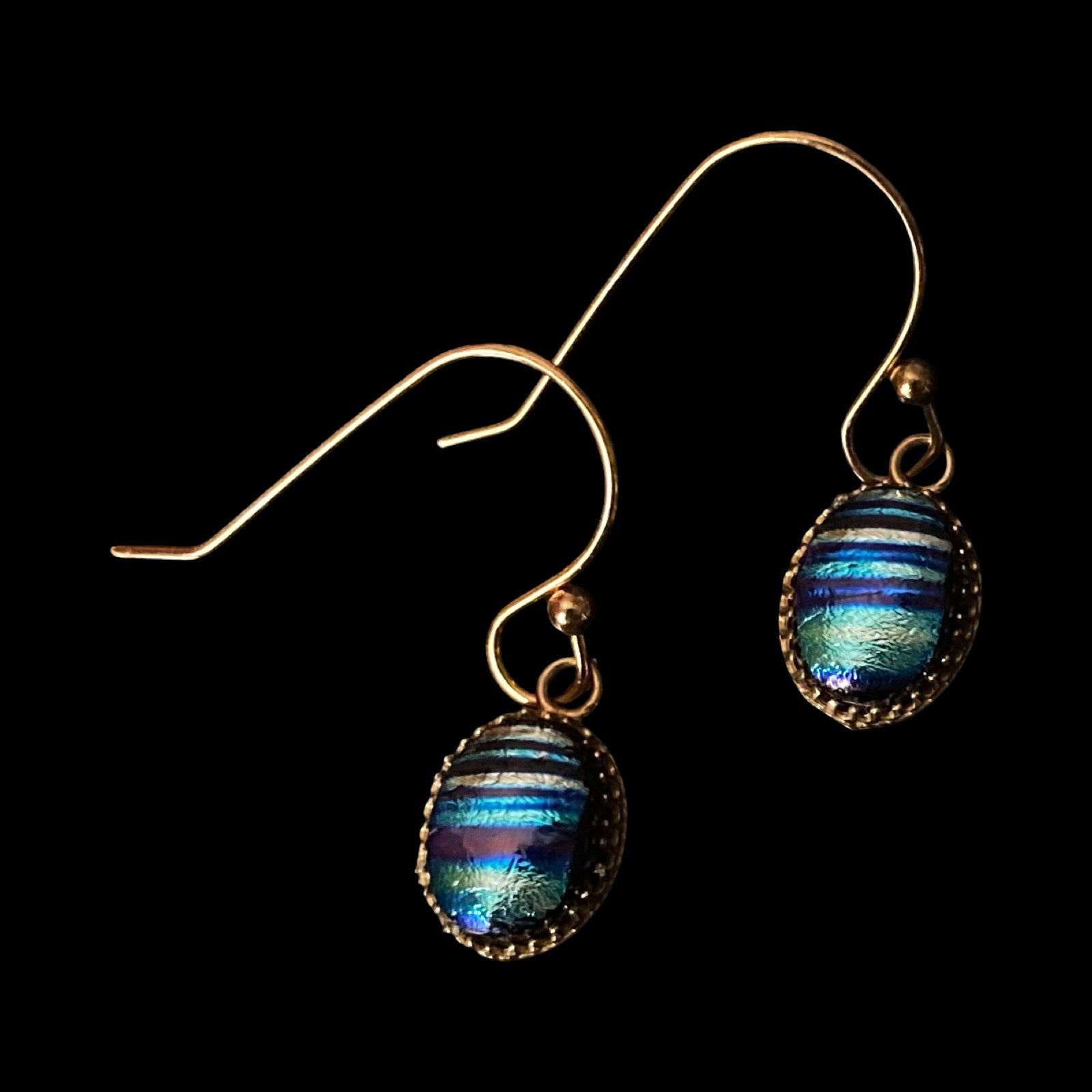 A pair of pierced earrings with a dainty blue striped dangle and gold ear wires, by 3D Glass Designs.