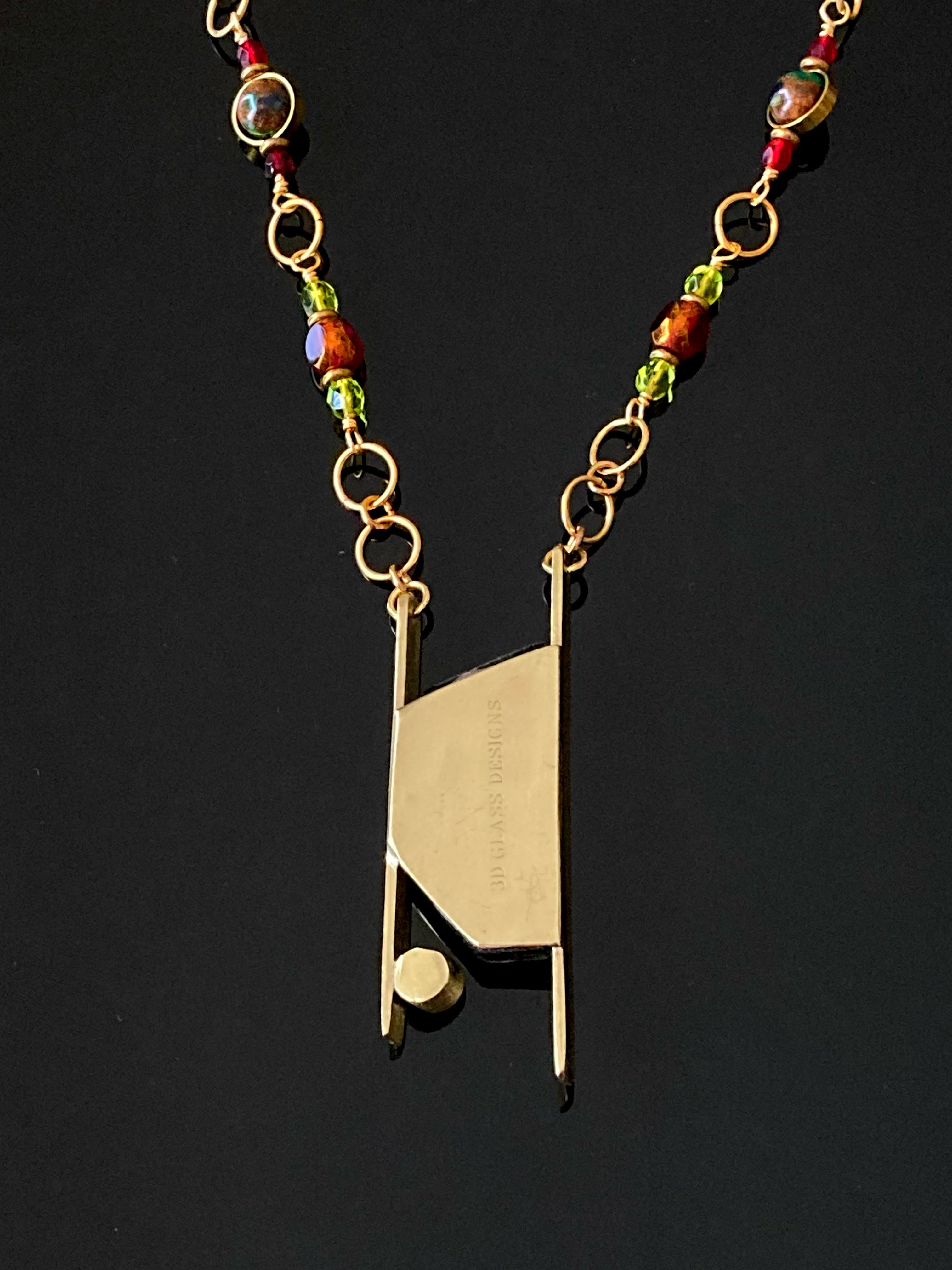 Back of brass pendant with colorful dichroic glass and beaded brass chain, by 3D Glass Designs.