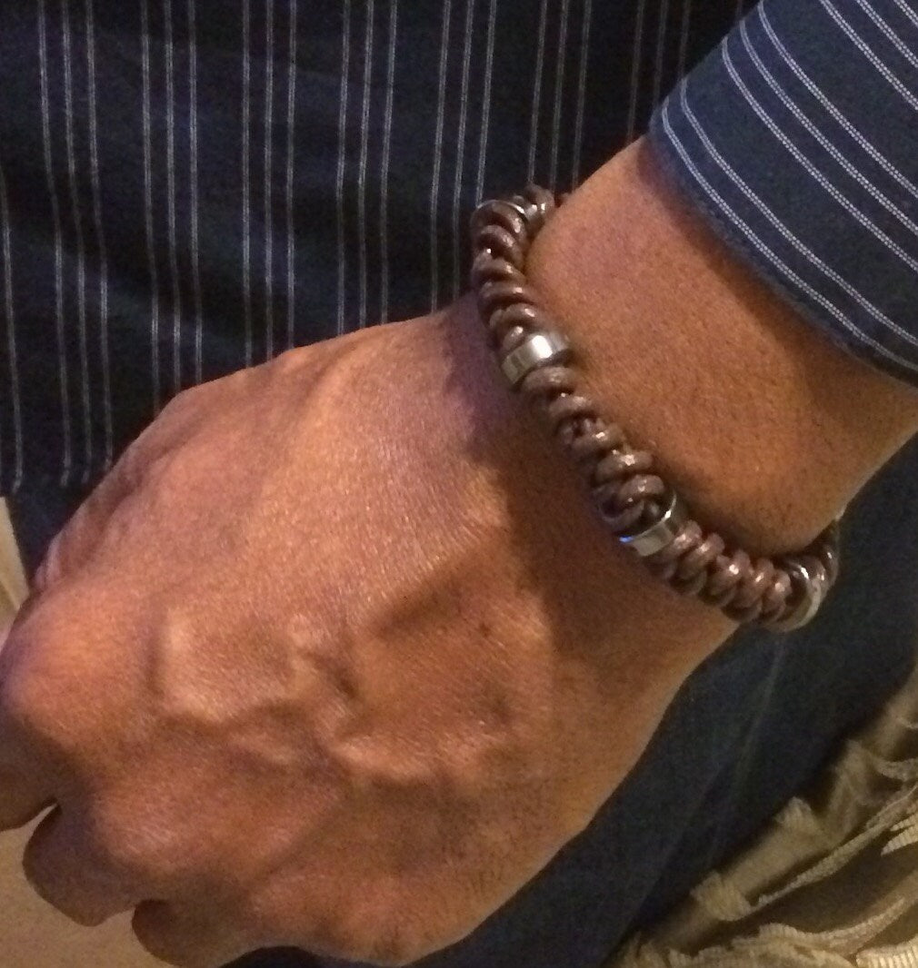 Model wearing brown Leather hand-knotted bracelet with hematite beads, by 3D Glass Designs.
