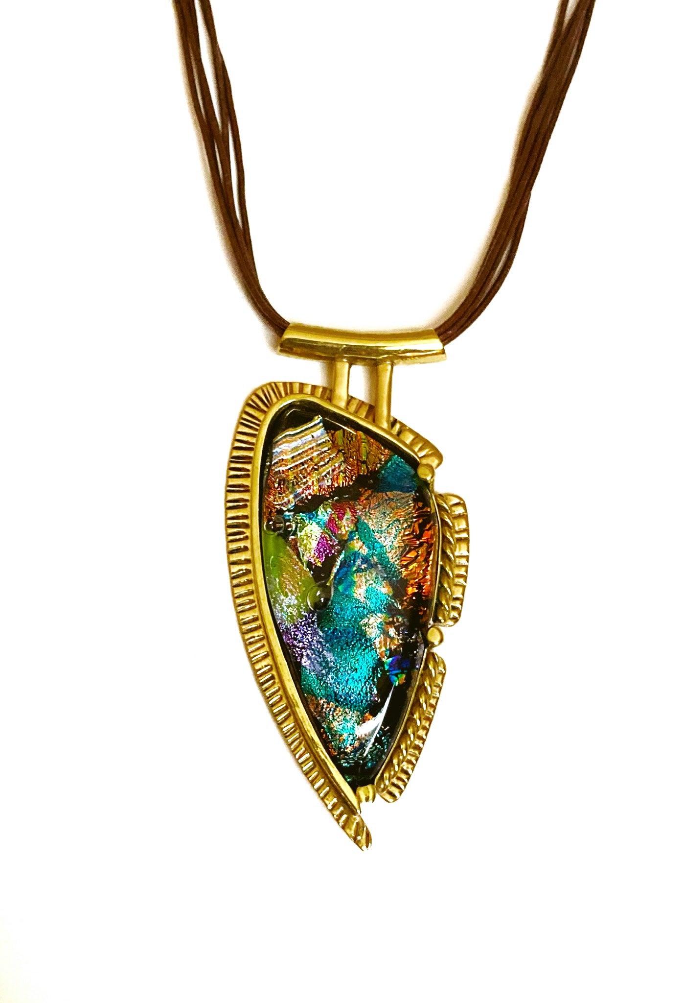 Handcrafted brass pendant featuring multicolored dichroic glass in a shield-shape hung on a multistrand leather necklace, by 3D Glass Designs.