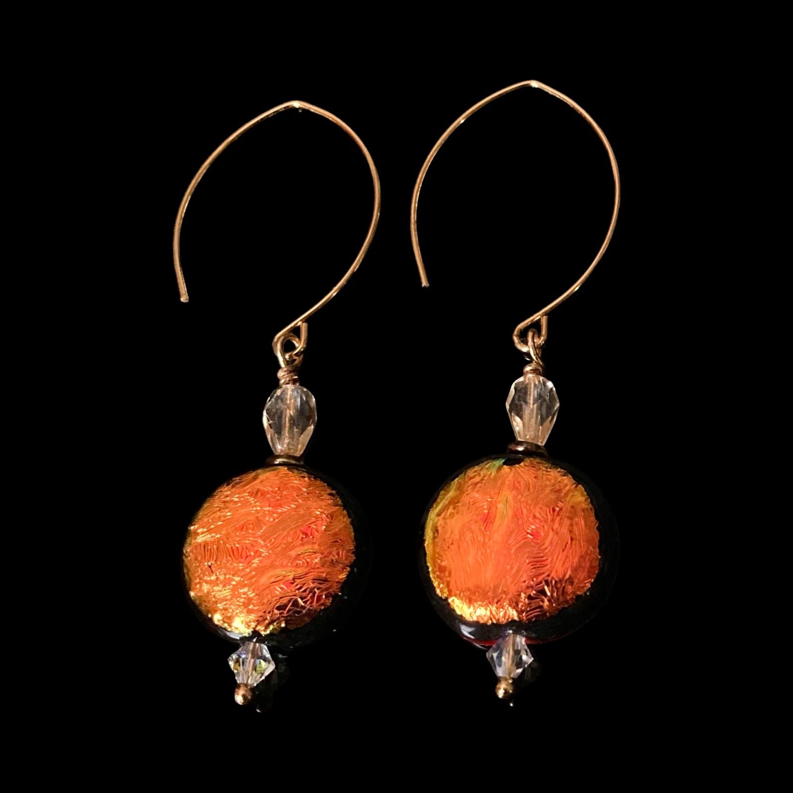 A pair of extra-long orange glass earrings with gold ear wires and crystal beads, by 3D Glass Designs.