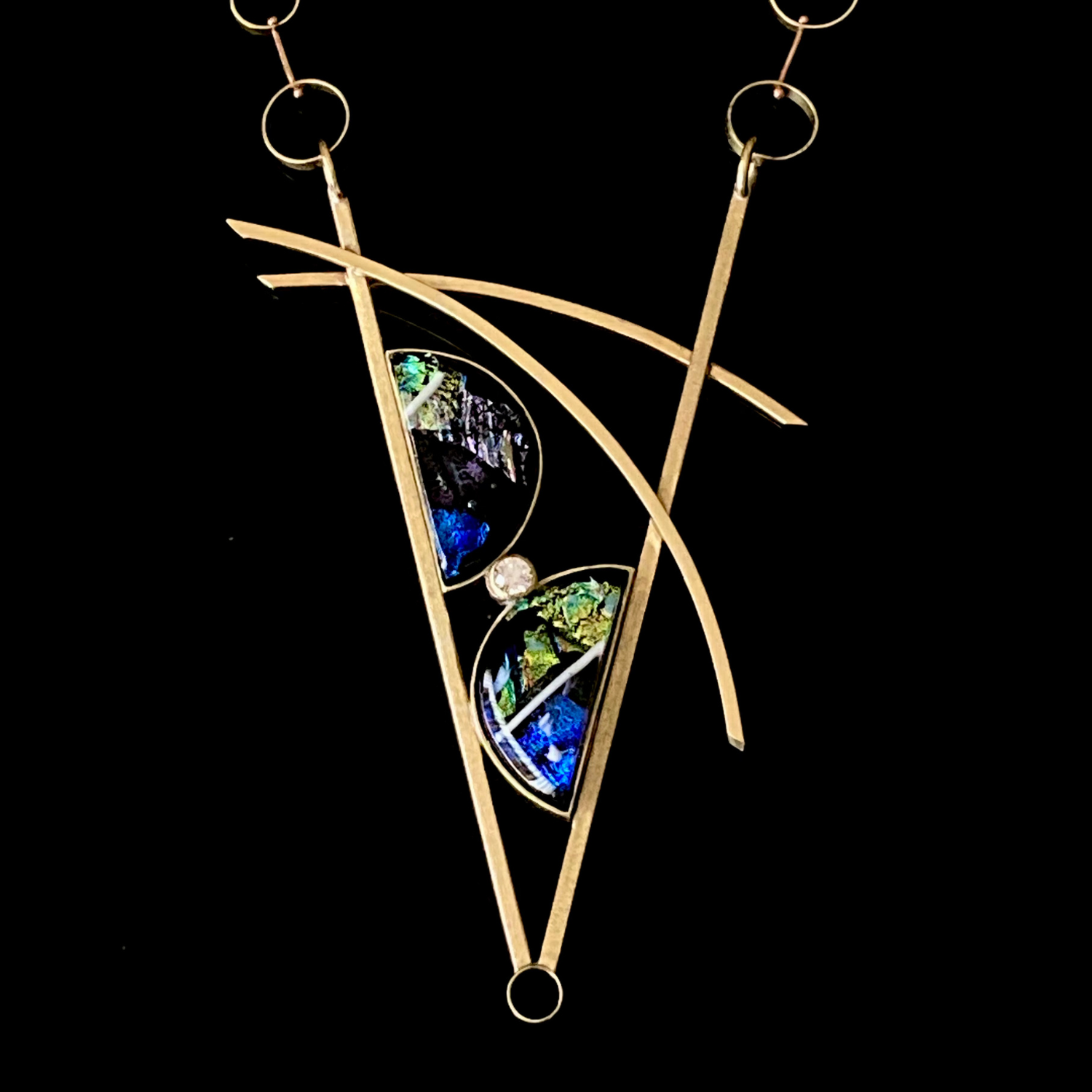 Geometric inspired brass pendant with teal fused glass in semi-circles and CZ, framed in a V with two slightly curved arch's above.  Necklace made of various sized circles linked together, by 3D Glass Designs.